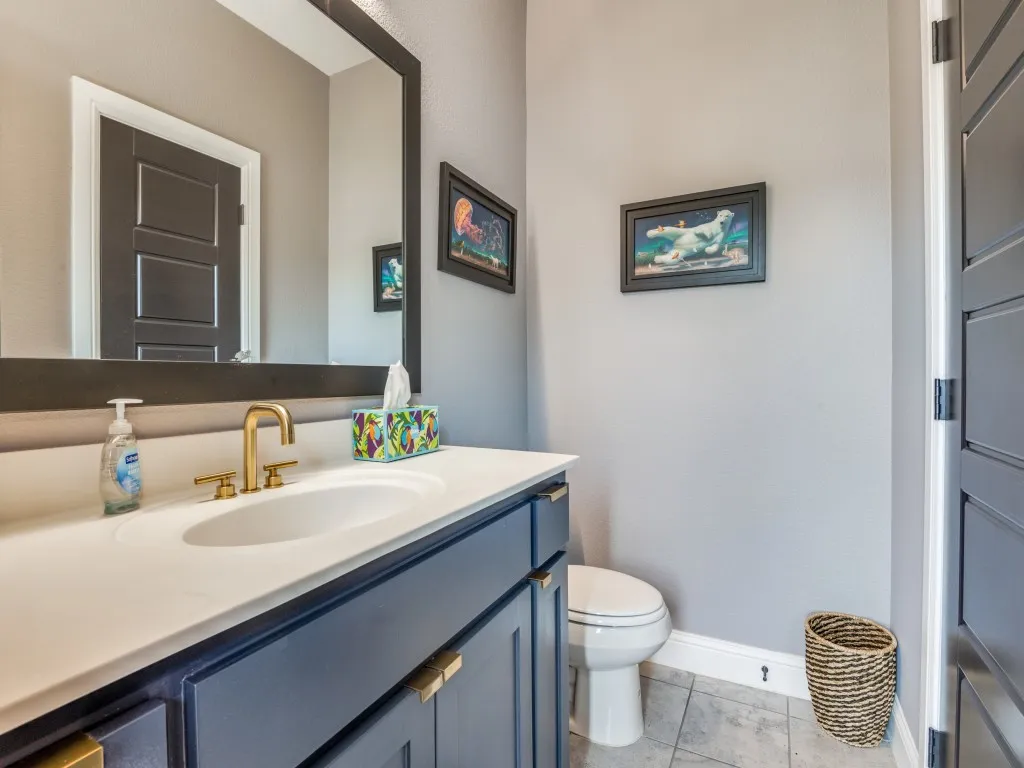 Half bath featuring vanity and tile patterned floors