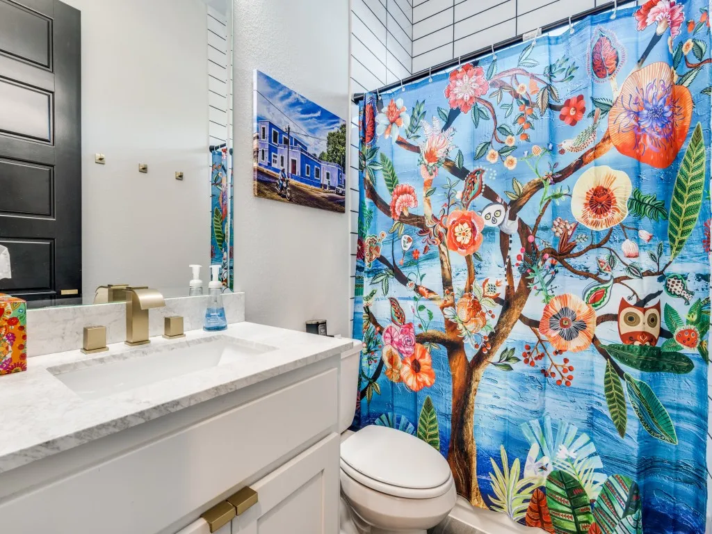 Full bathroom with vanity and a shower with shower curtain