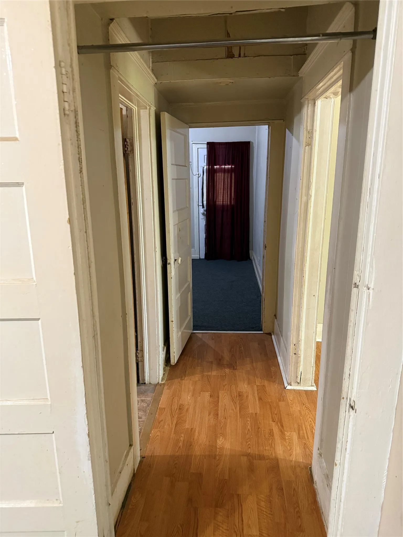 Hallway featuring wood-finish flooring