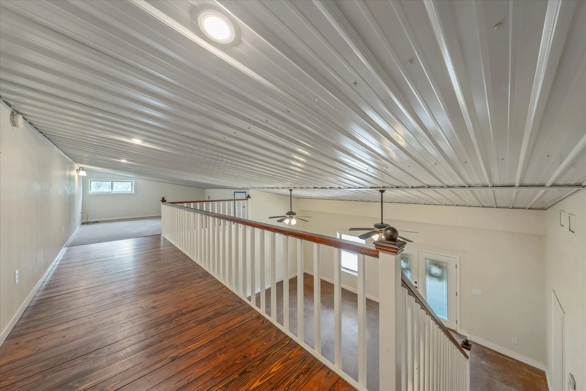 Hallway with dark wood-style floors and baseboards