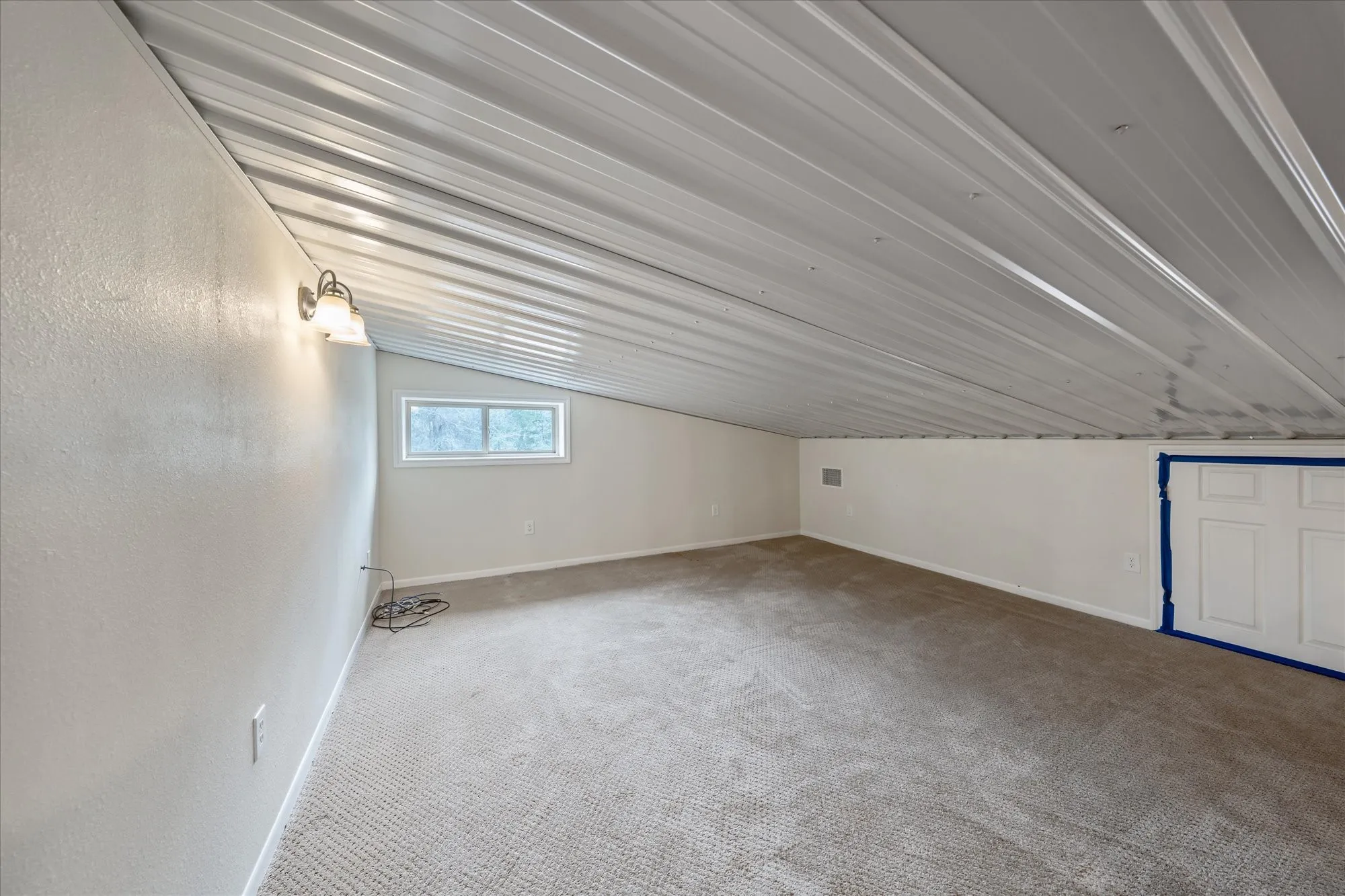 Bedroom room with vaulted ceiling and carpet floors