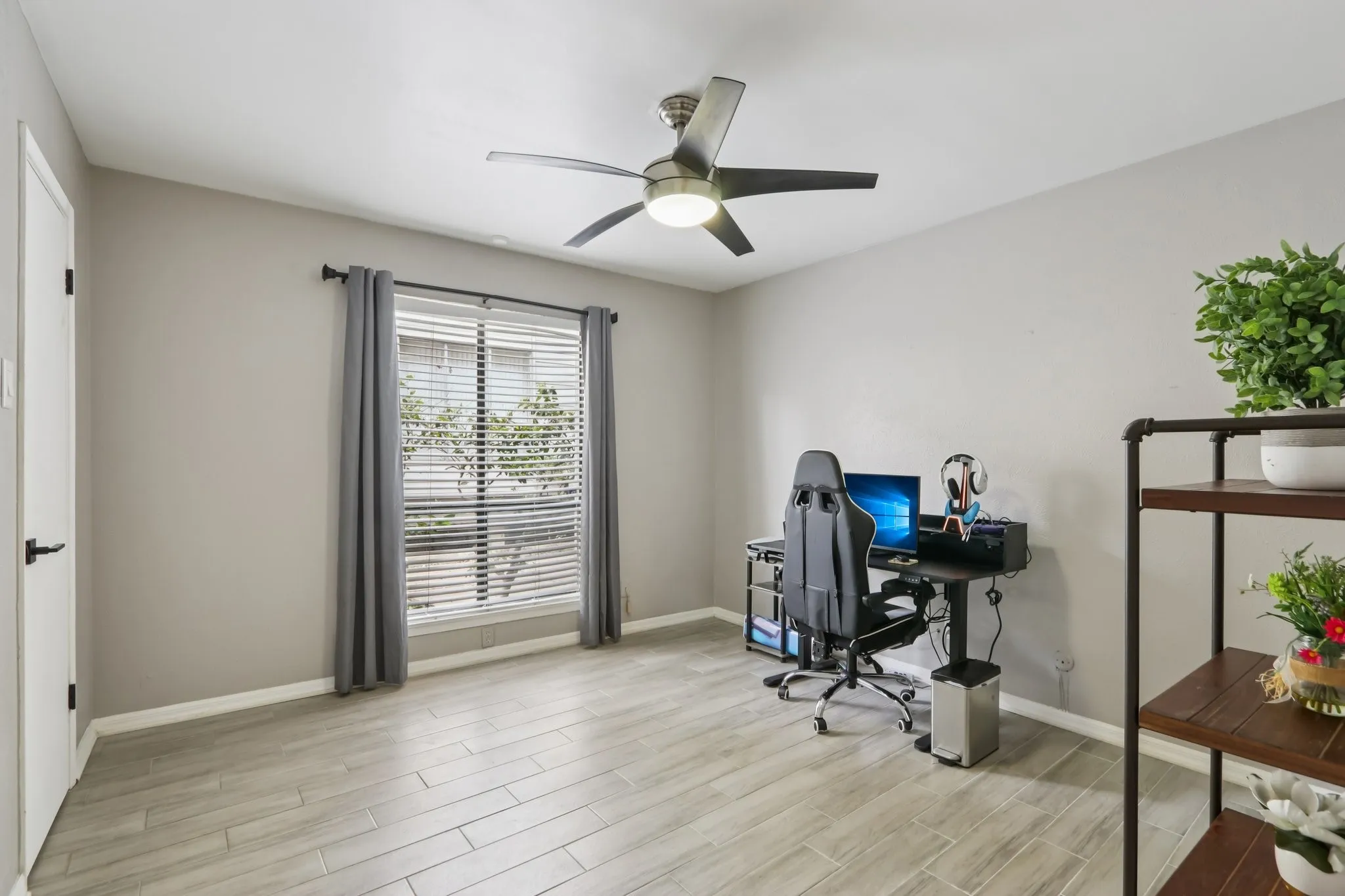 Home office featuring wood tiled floors and a ceiling fan