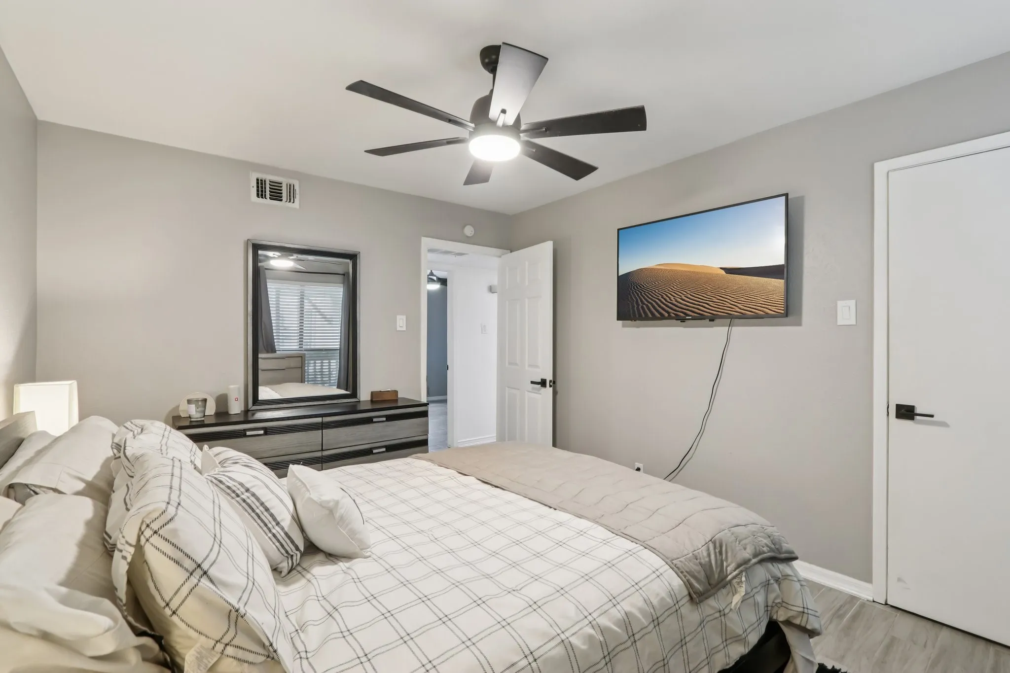 Bedroom with a ceiling fan and wood finished floors