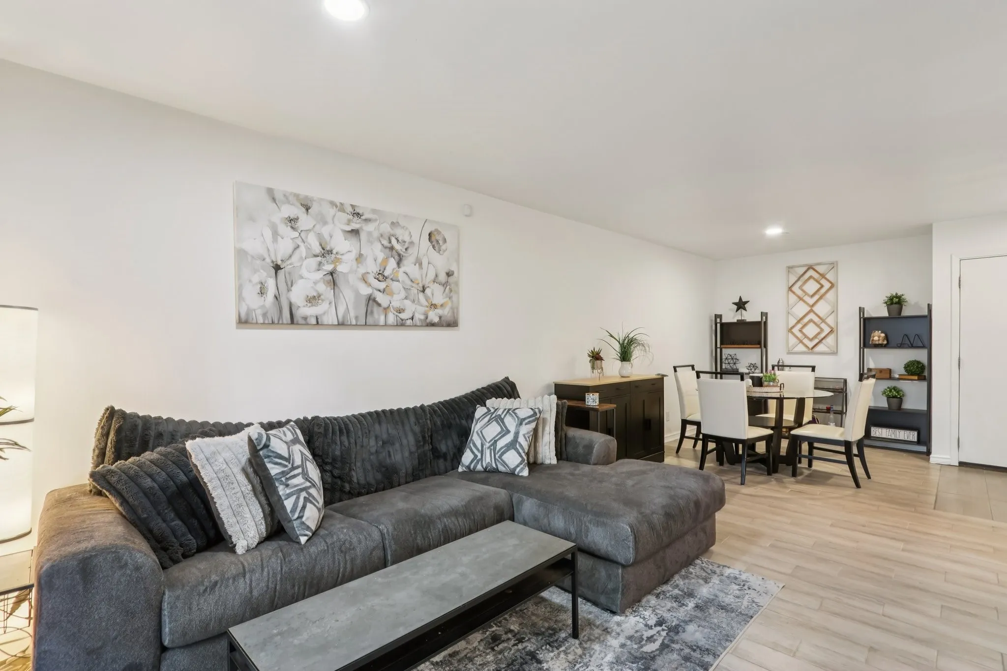 Living room with light wood finished floors and recessed lighting