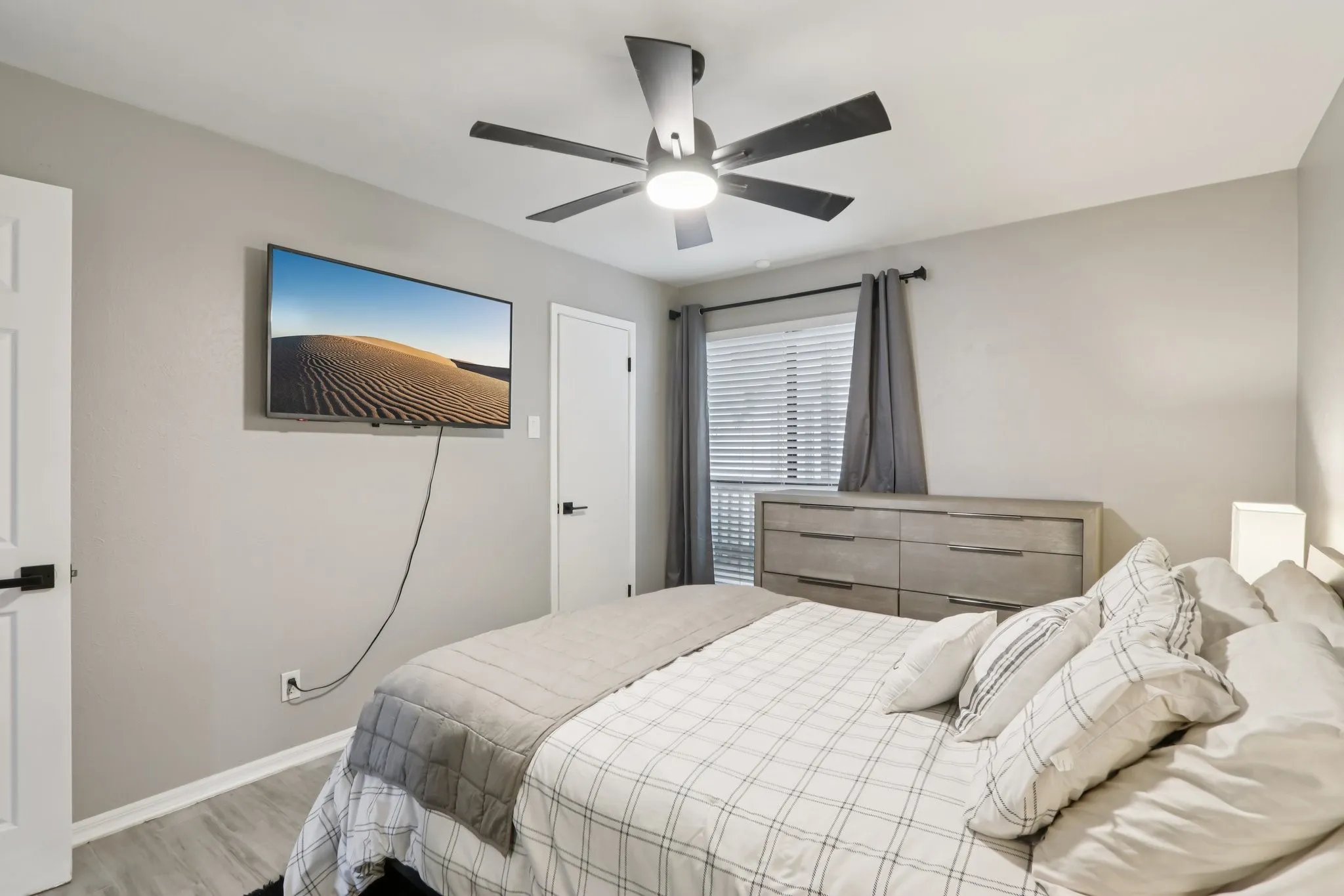 Bedroom with ceiling fan and light wood-style floors
