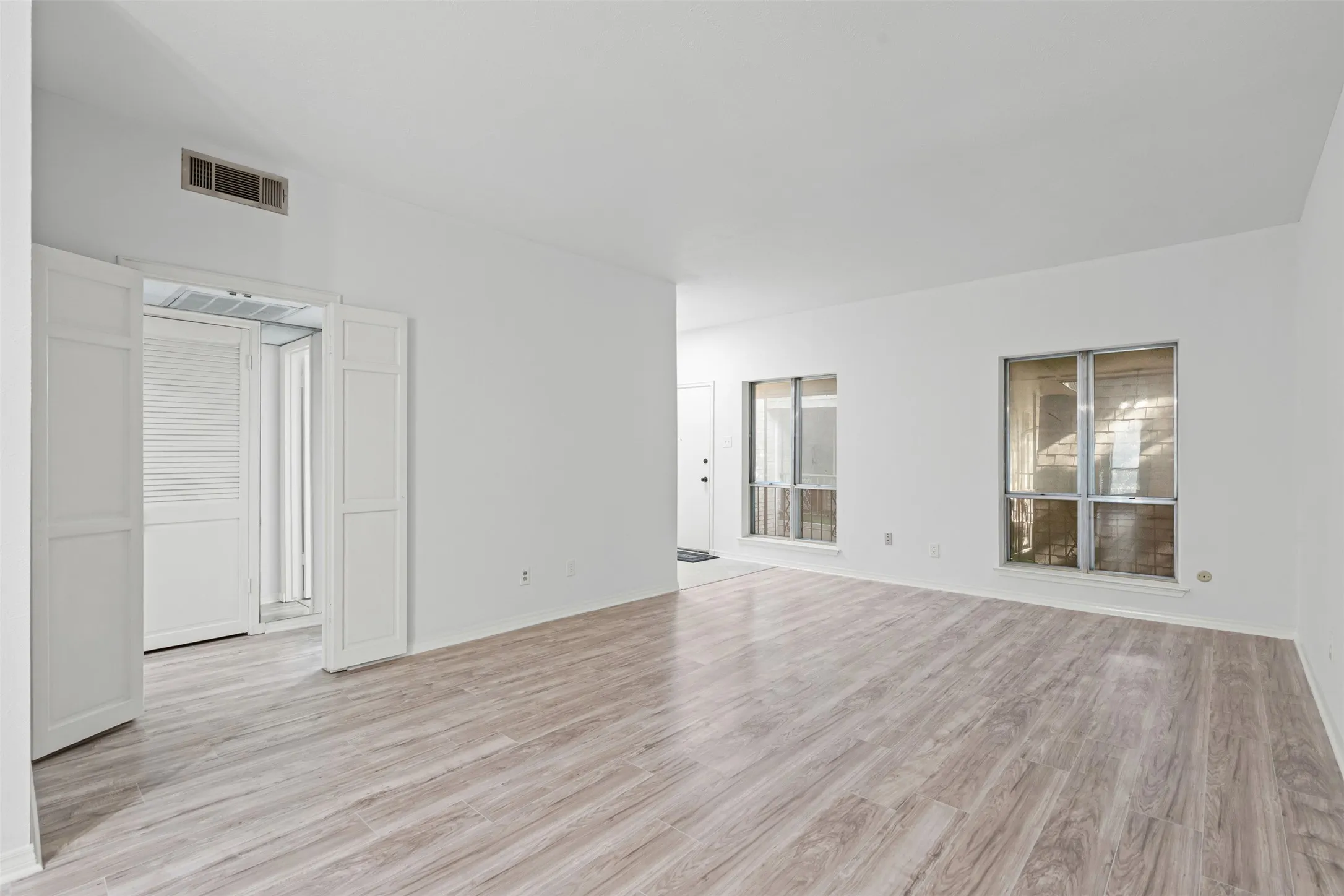 Dining looking into hall, living and front entry. This photo was used for the virtual staging photo.