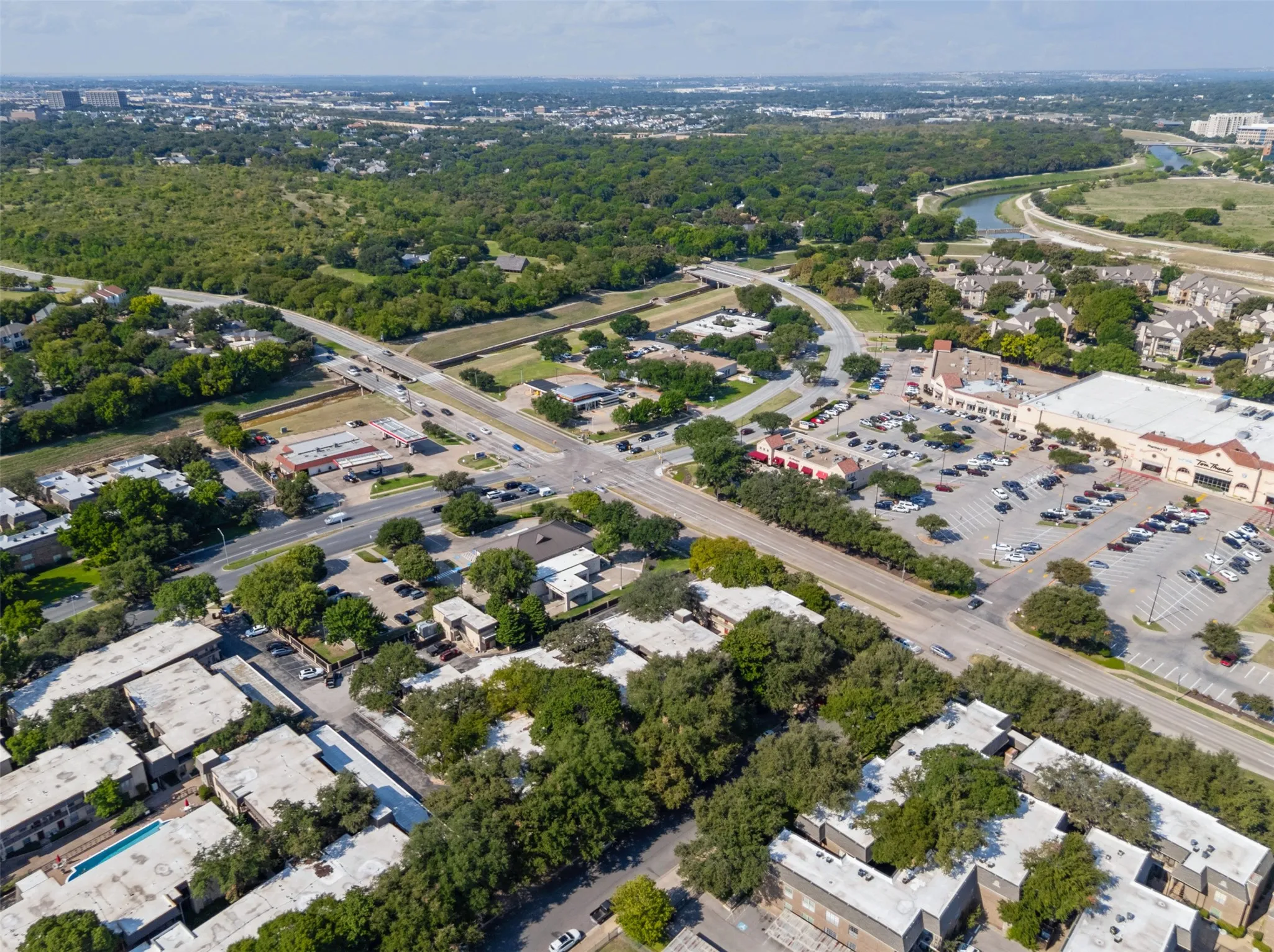 Aerial View of condo with views of the shopping center and the Trinity River in the background.
