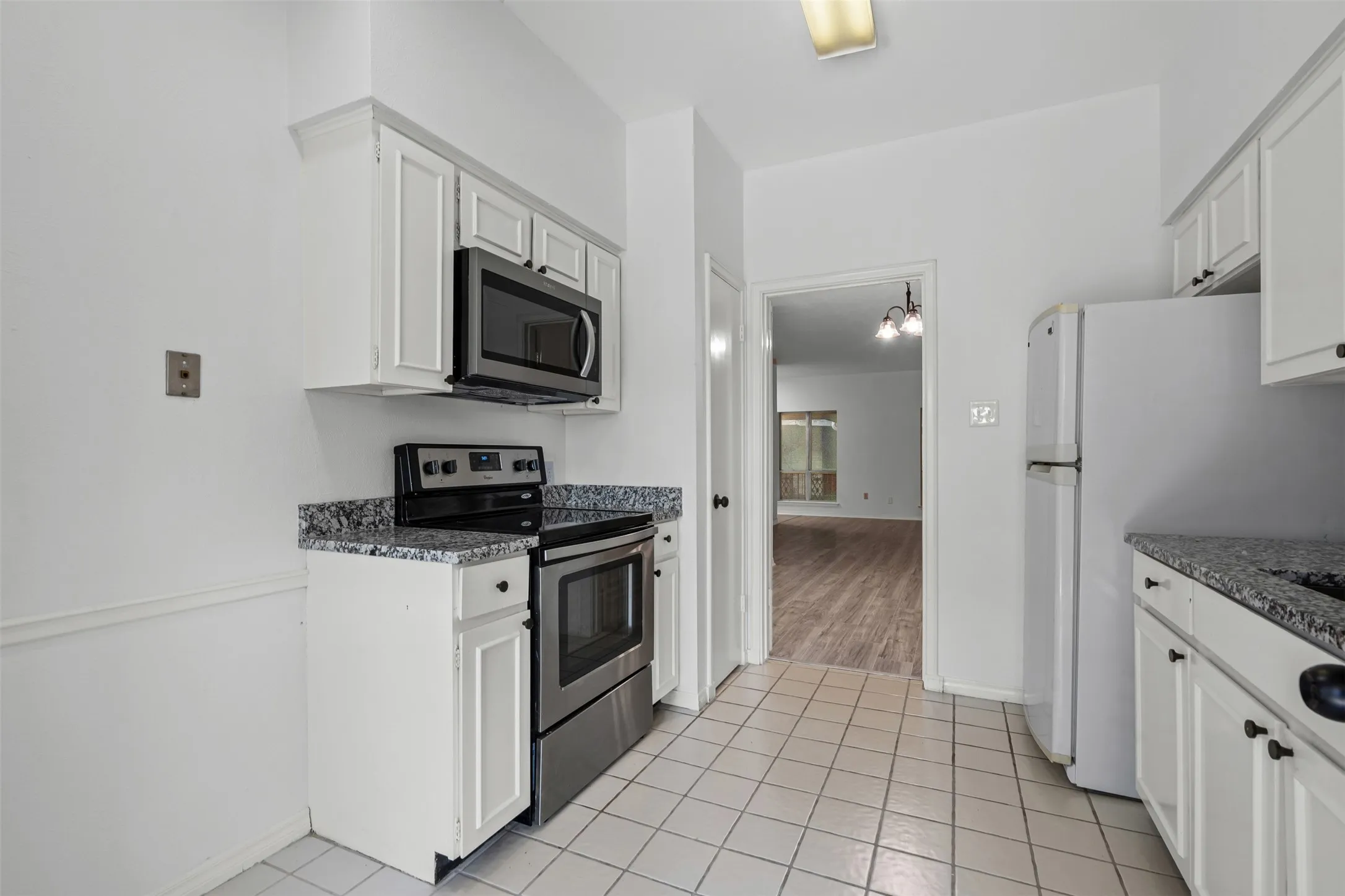 Kitchen with new microwave and dishwasher.