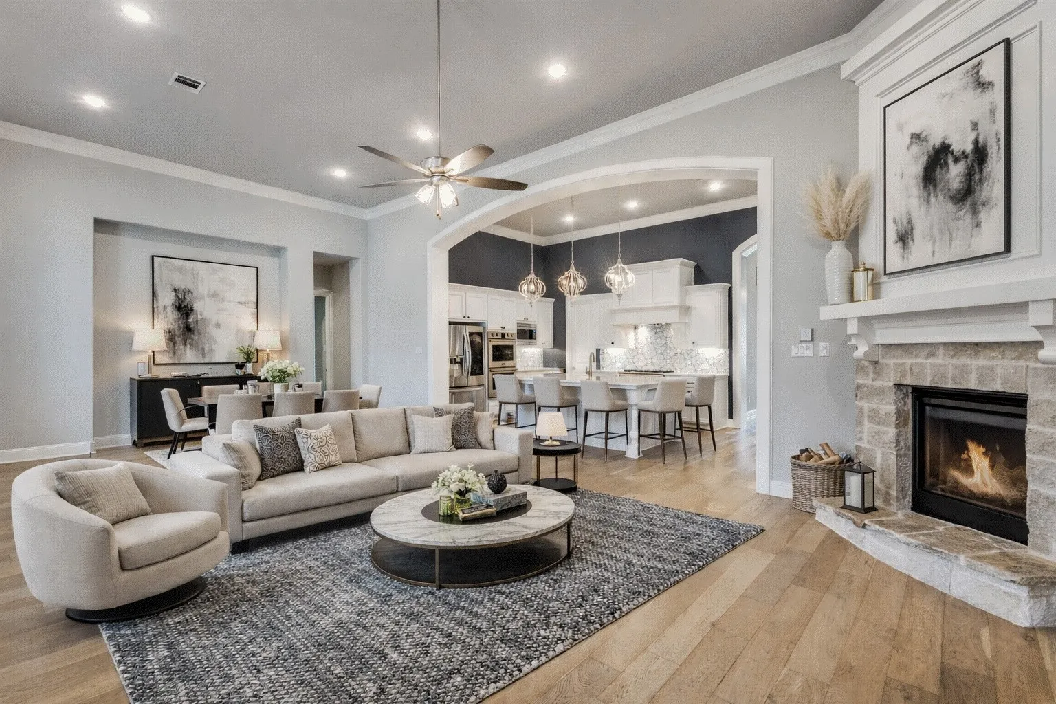 Living room with crown molding, a stone fireplace, light wood-style floors, ceiling fan, and recessed lighting.  AI staged photo
