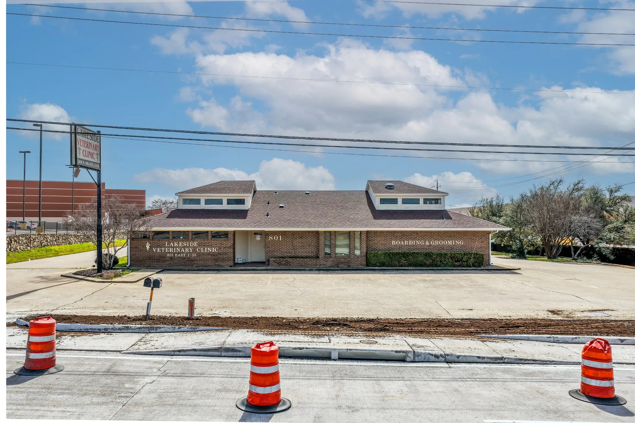 View of front facade featuring brick siding and a shingled roof