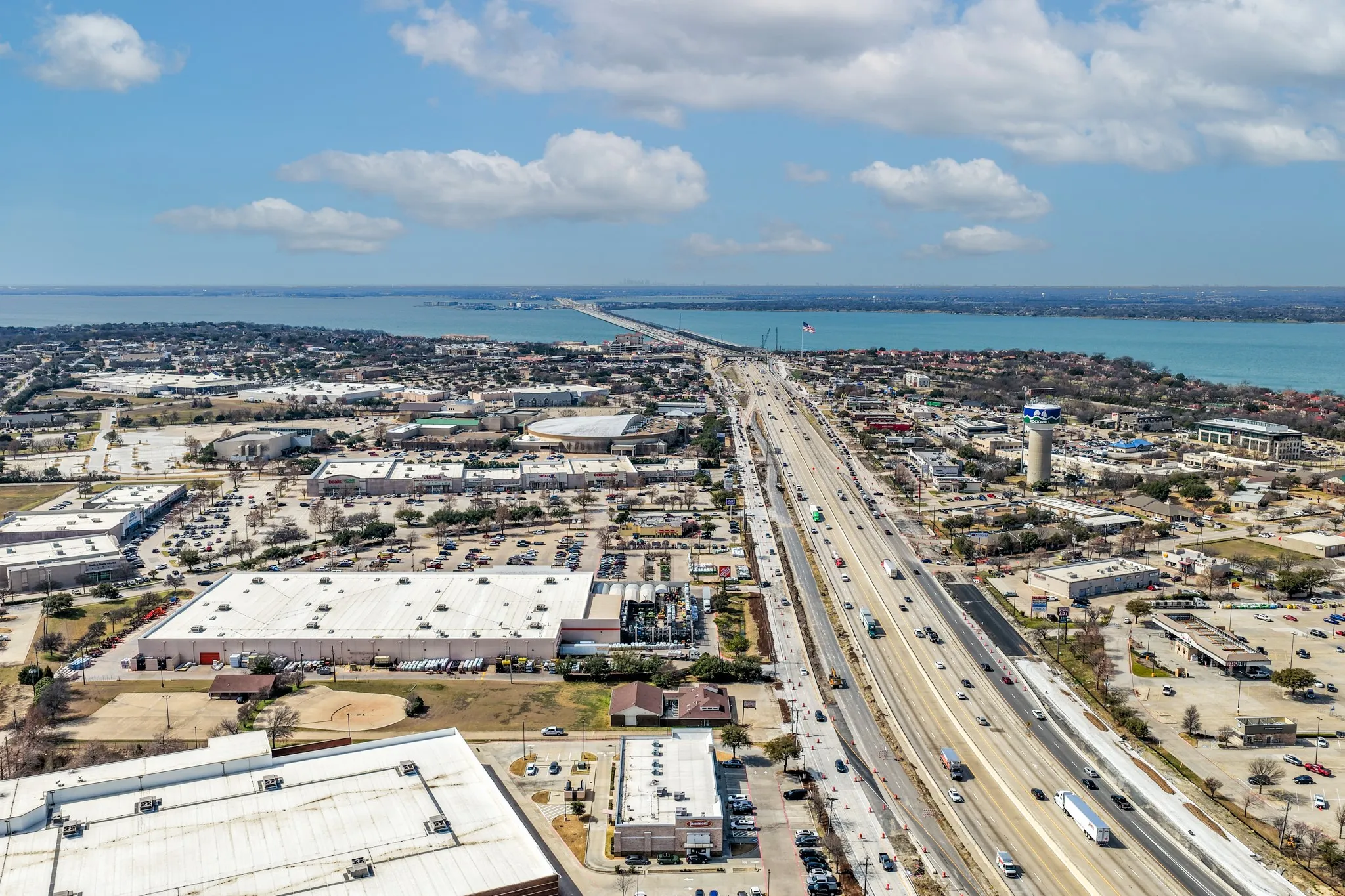 Bird's eye view of a nearby body of water and a main thoroughfare