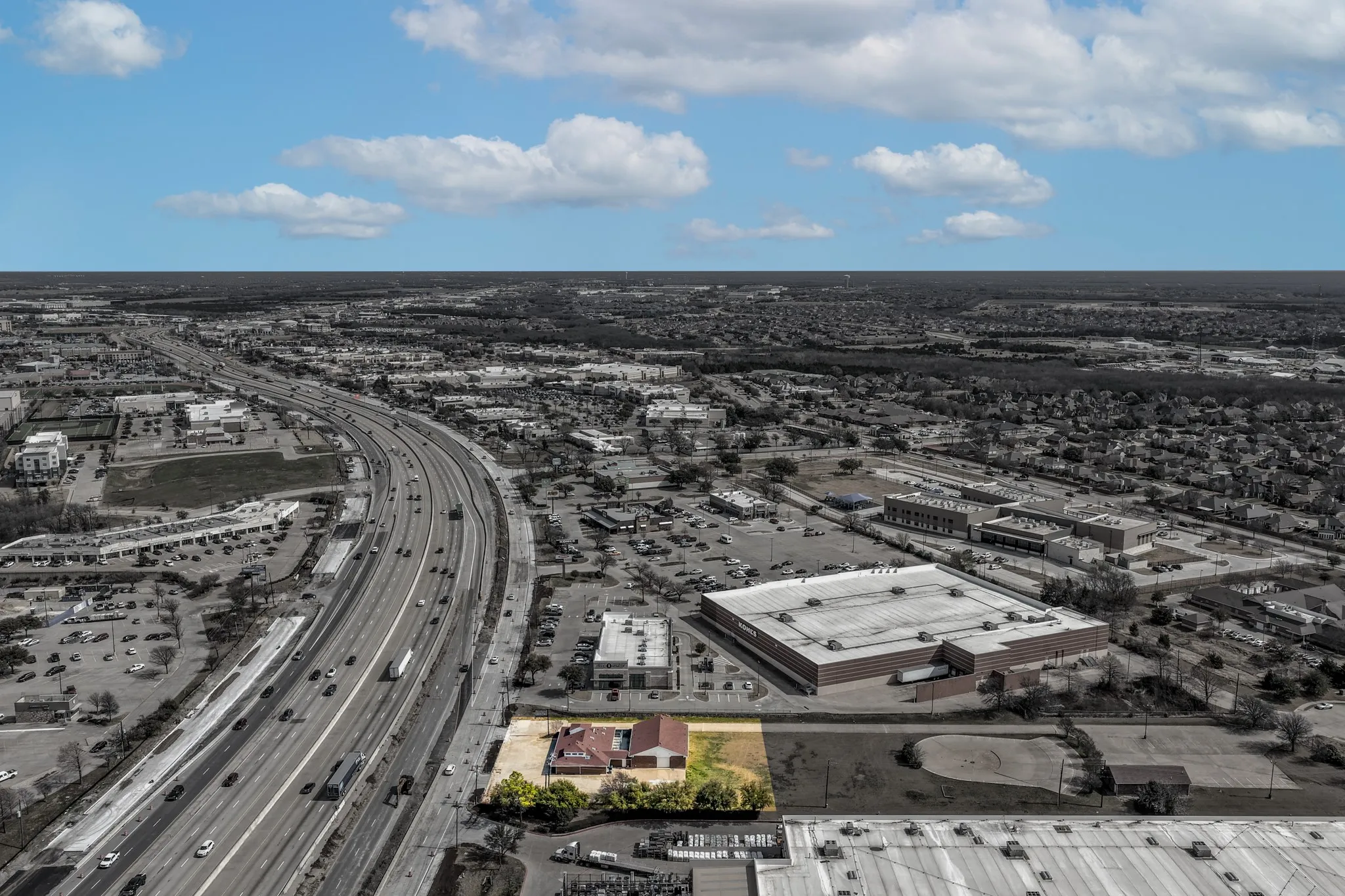 Drone / aerial view of a major roadway and property