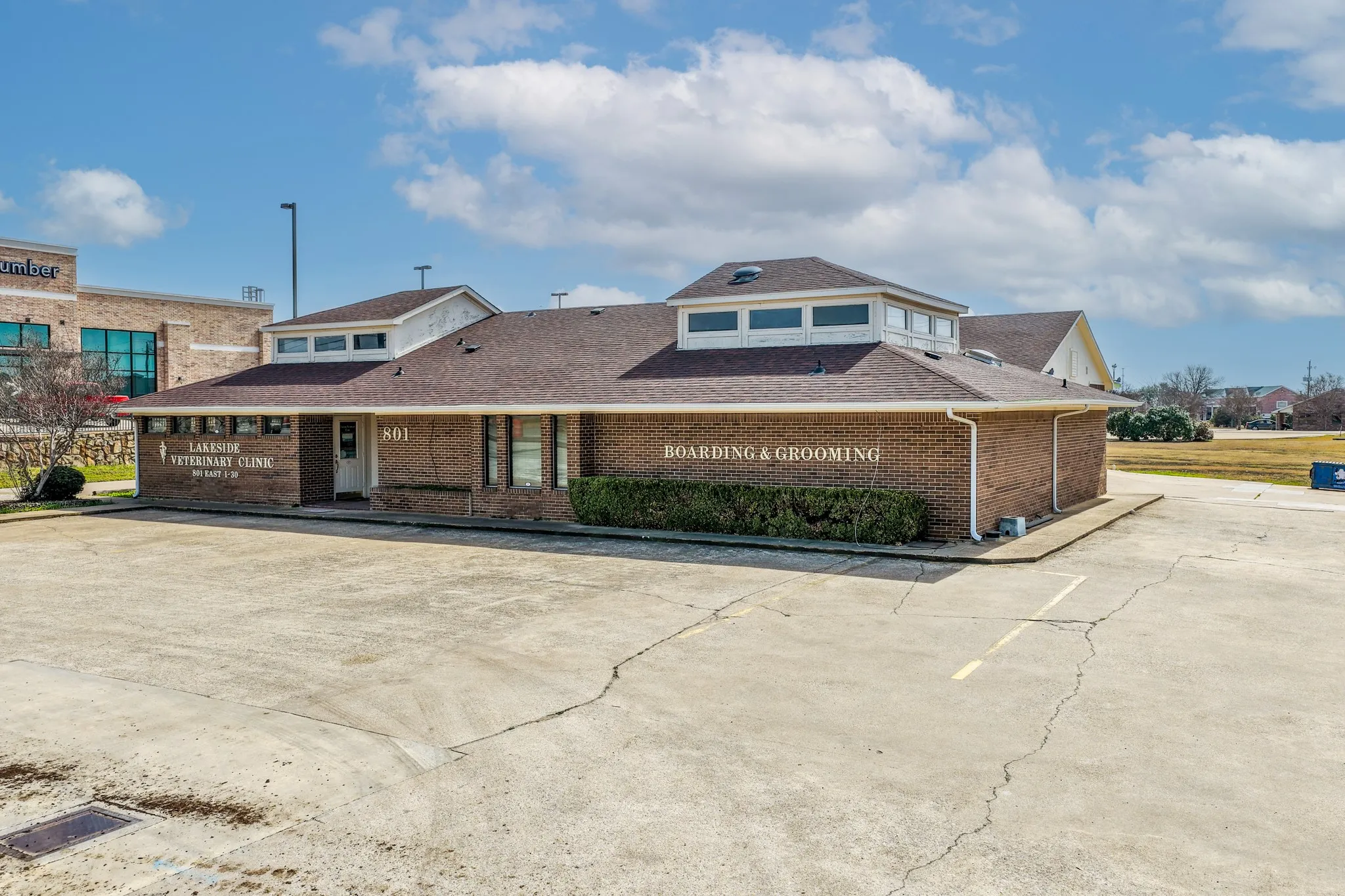 View of property featuring uncovered parking