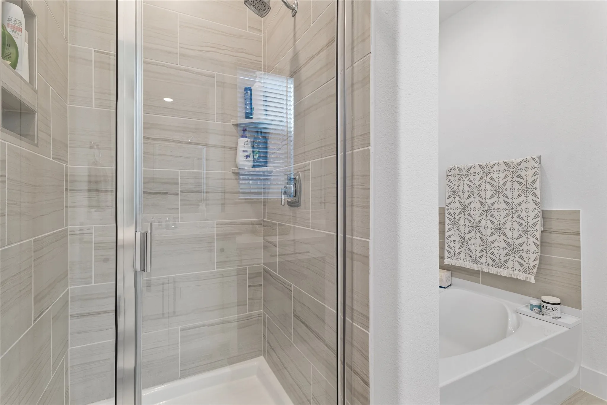 Bathroom with a stall shower and a bath