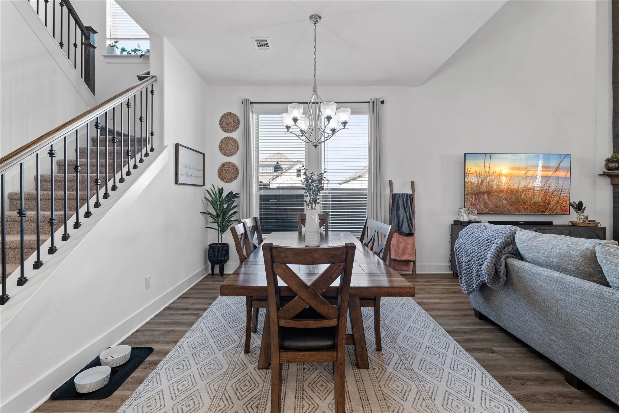 Dining room with healthy amount of natural light, dark wood finished floors, and suspended lighting