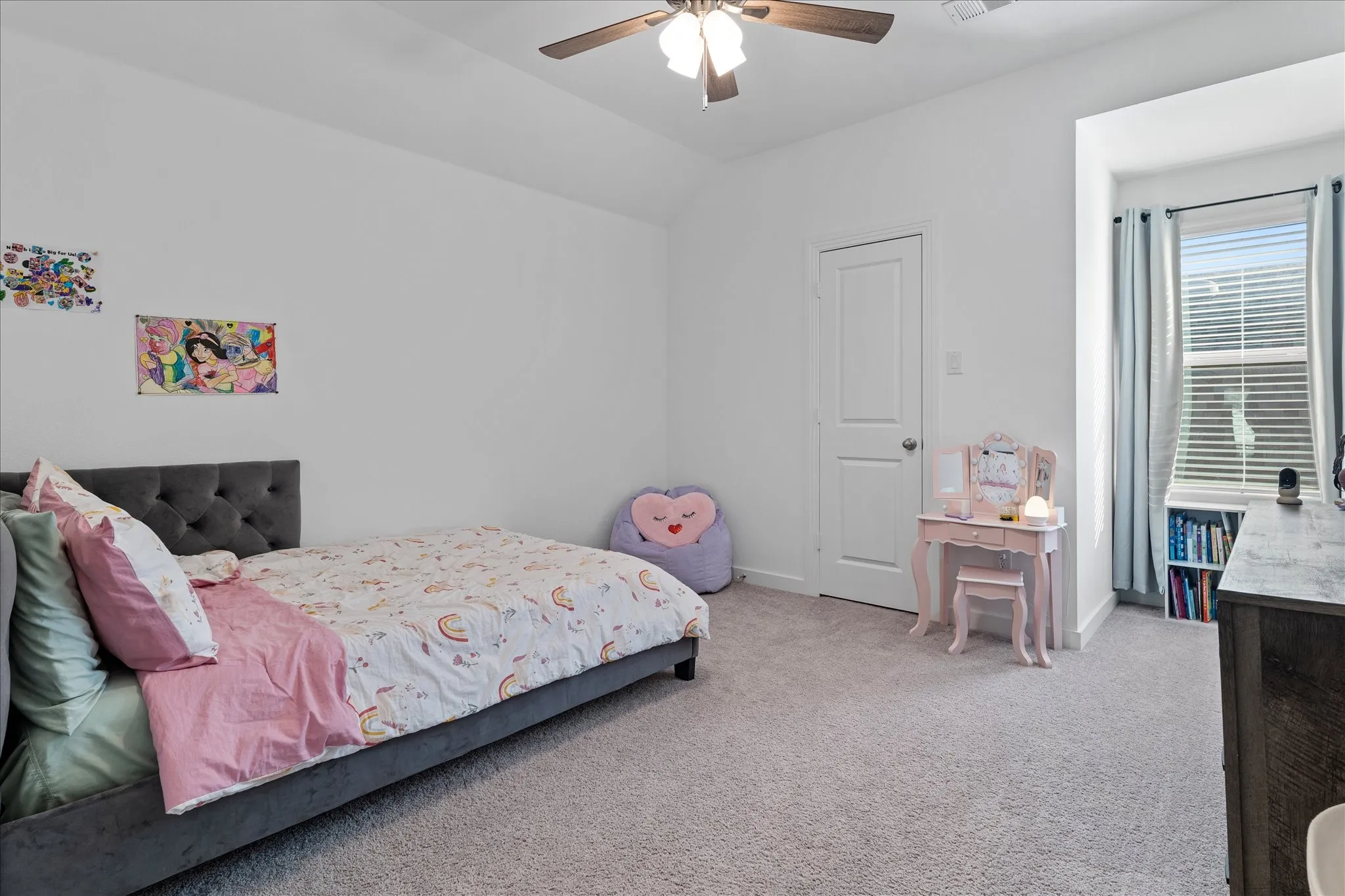 Bedroom with light colored carpet, lofted ceiling, and a ceiling fan