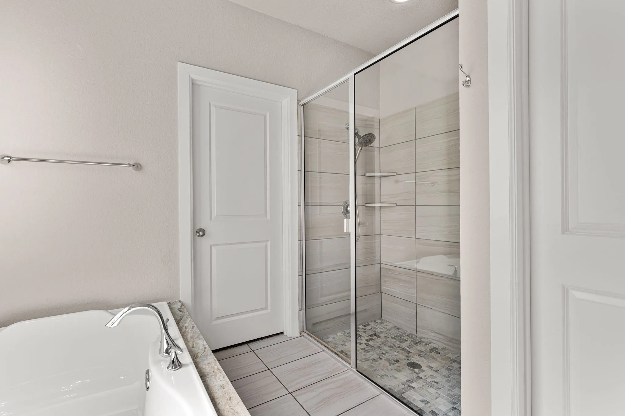 Full bathroom with a garden tub, a stall shower, and light tile patterned floors