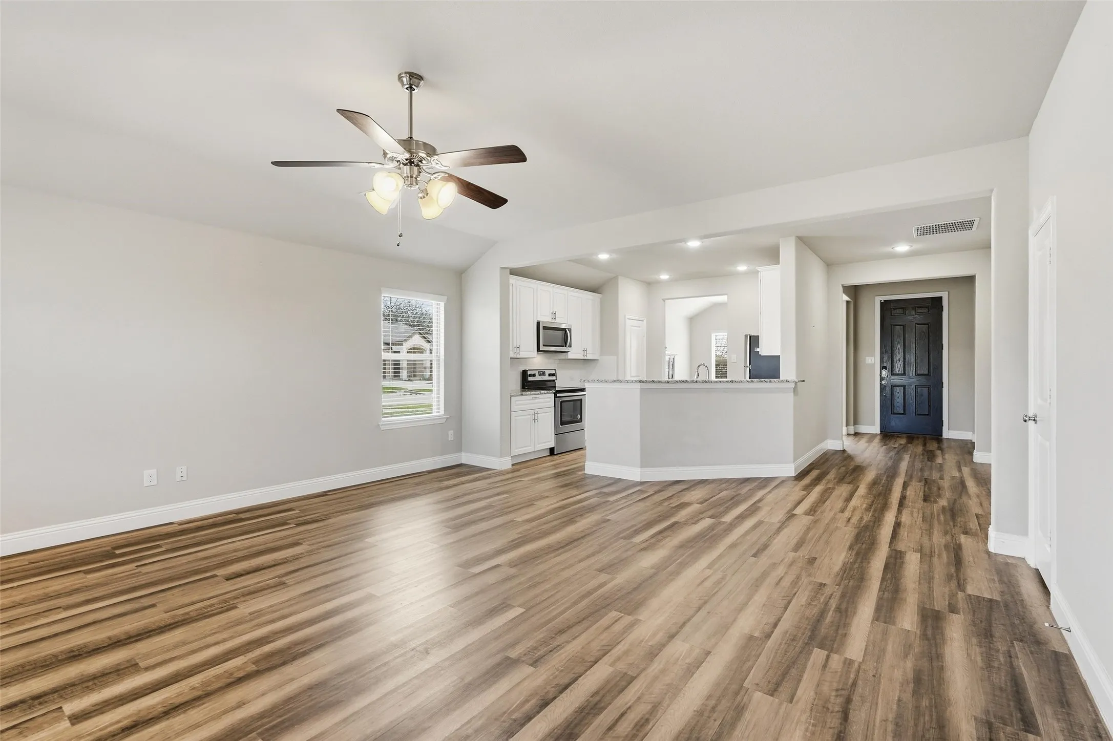 Very spacious living room that opens to the covered patio and large backyard.