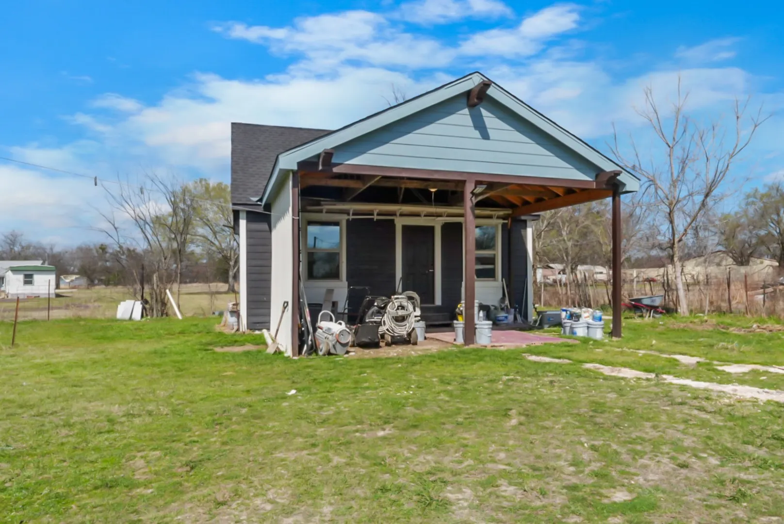 Back of house with a lawn and a patio area