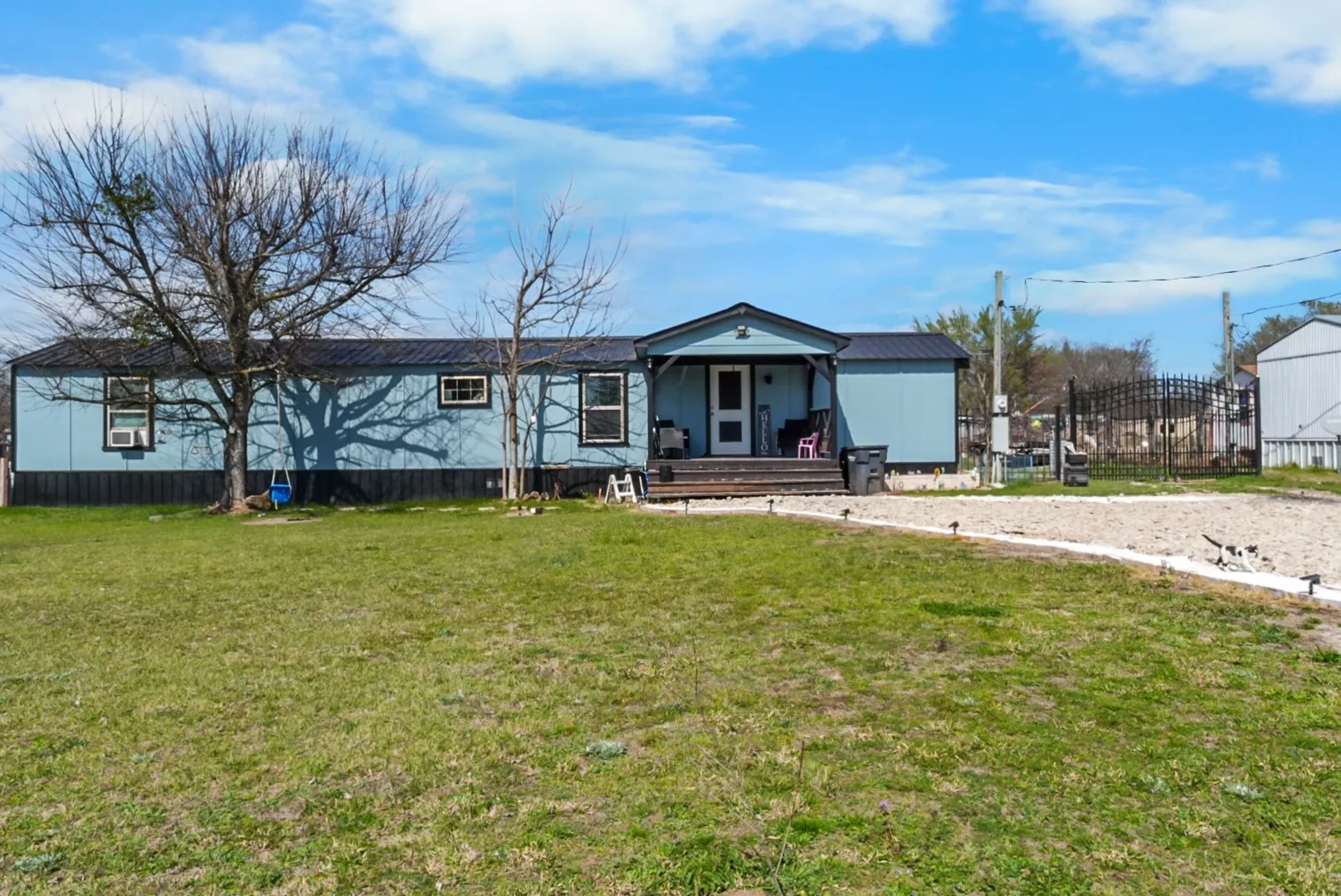 View of front of house featuring a wooden deck