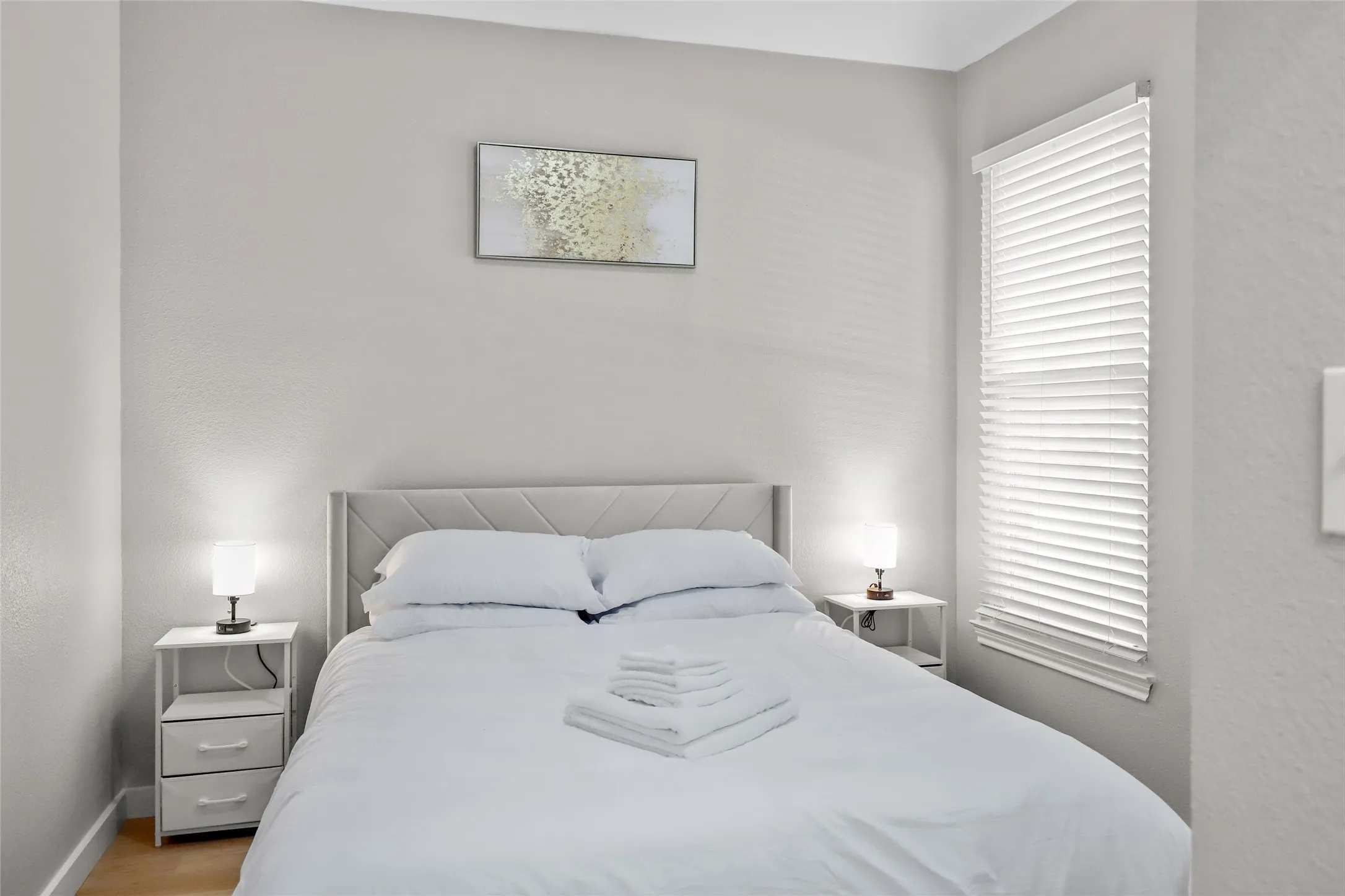 Bedroom featuring light wood-style flooring and baseboards