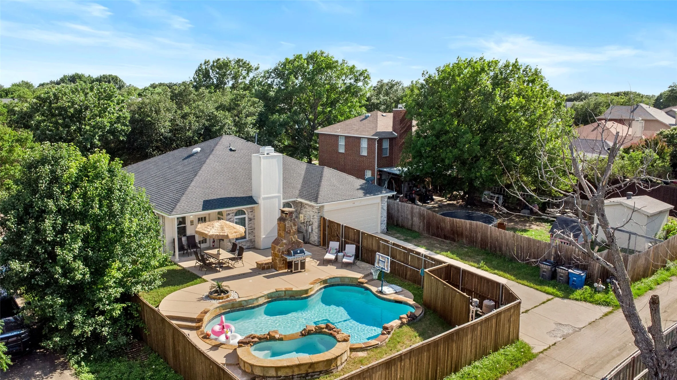View of pool with a fenced backyard, a patio area, and a pool with connected hot tub