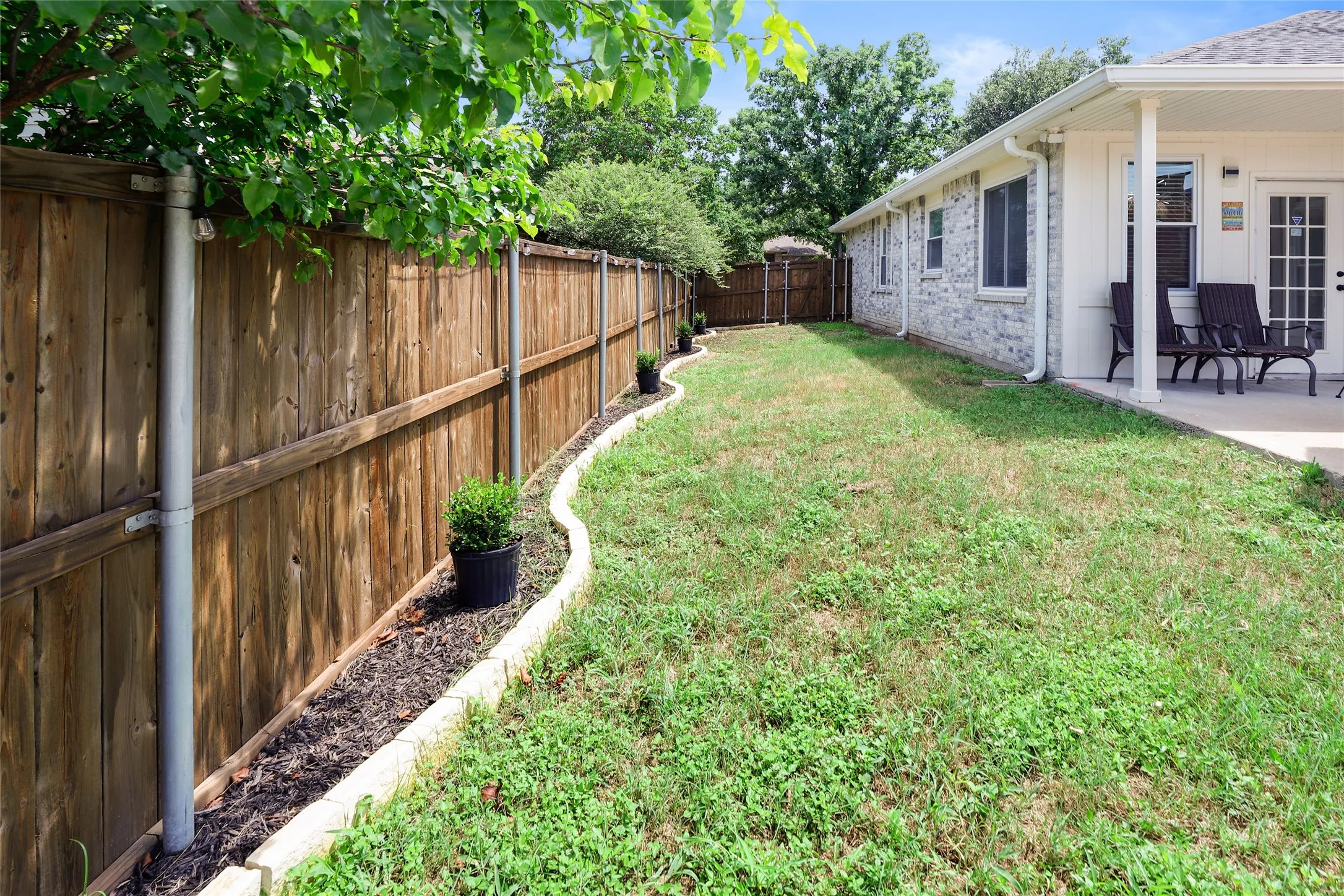 Fenced backyard featuring a patio