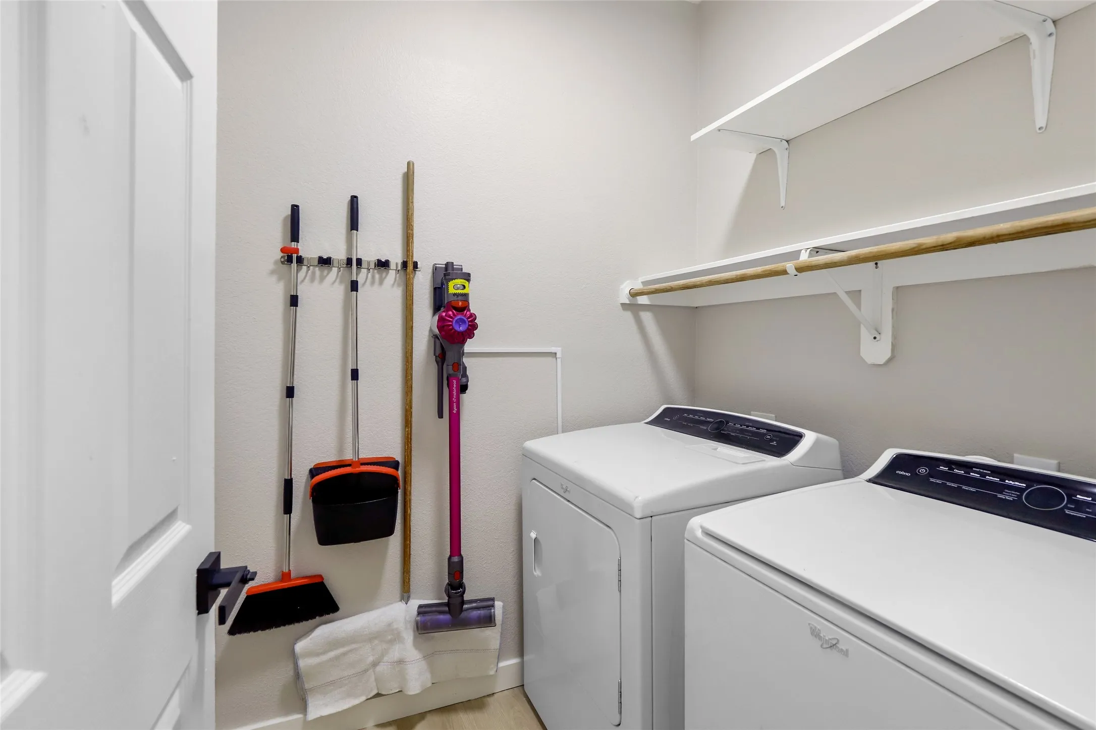Laundry area with washing machine and dryer and light wood-type flooring