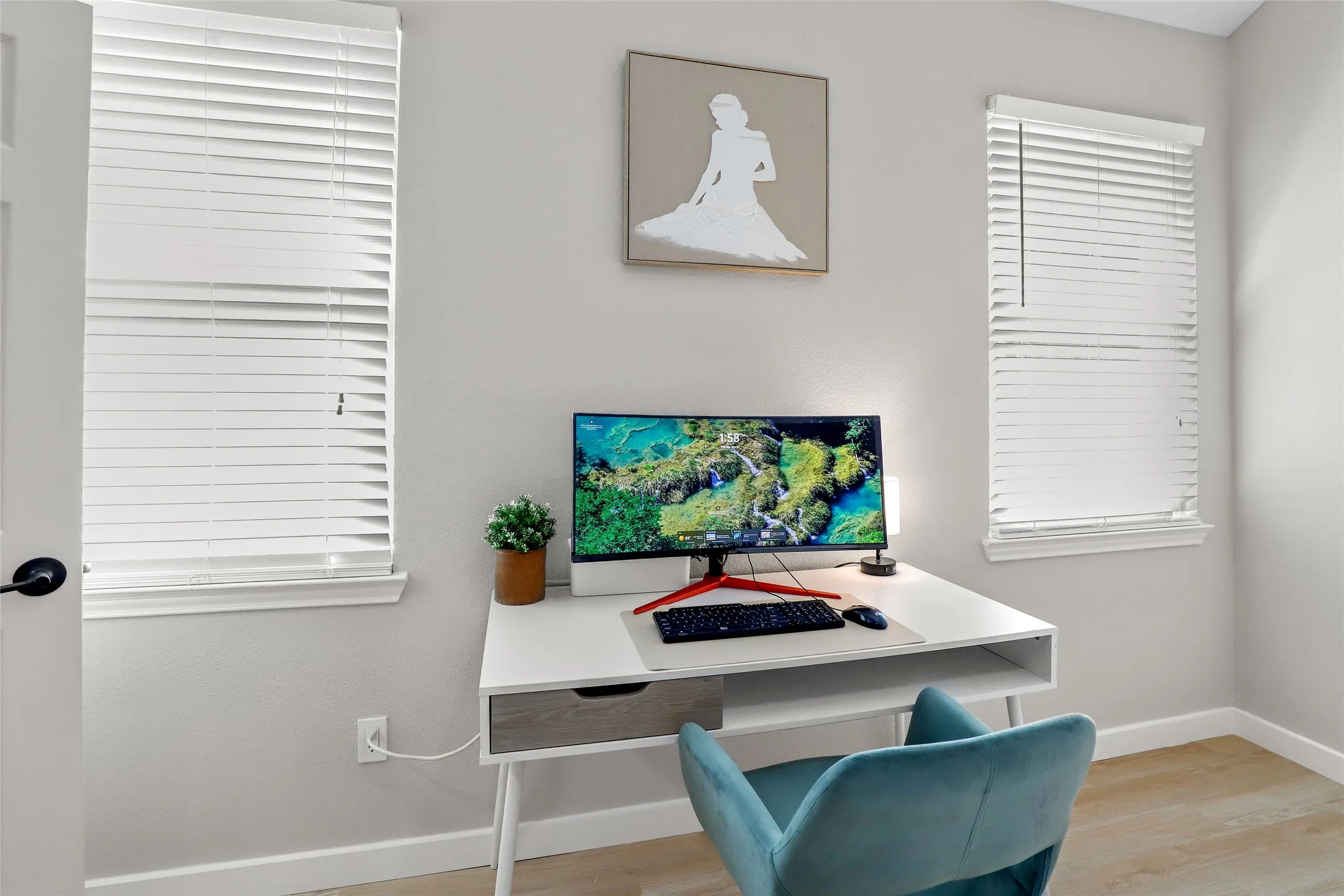 Home office with baseboards and wood finished floors