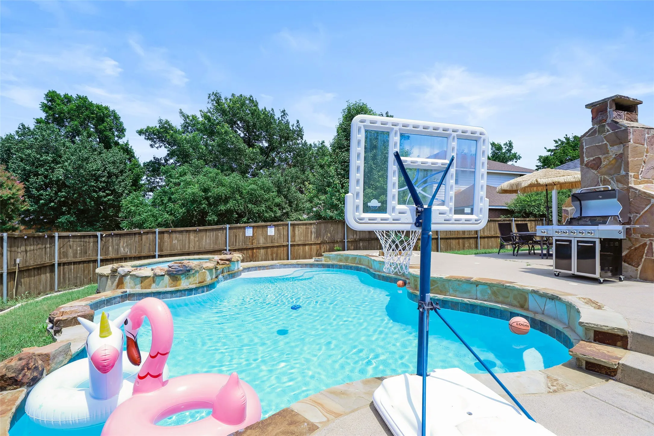 View of pool featuring a fenced backyard, a patio, and a pool with connected hot tub
