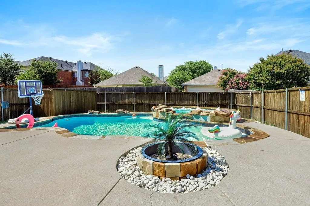 View of pool featuring a fenced backyard, an outdoor fire pit, and a patio
