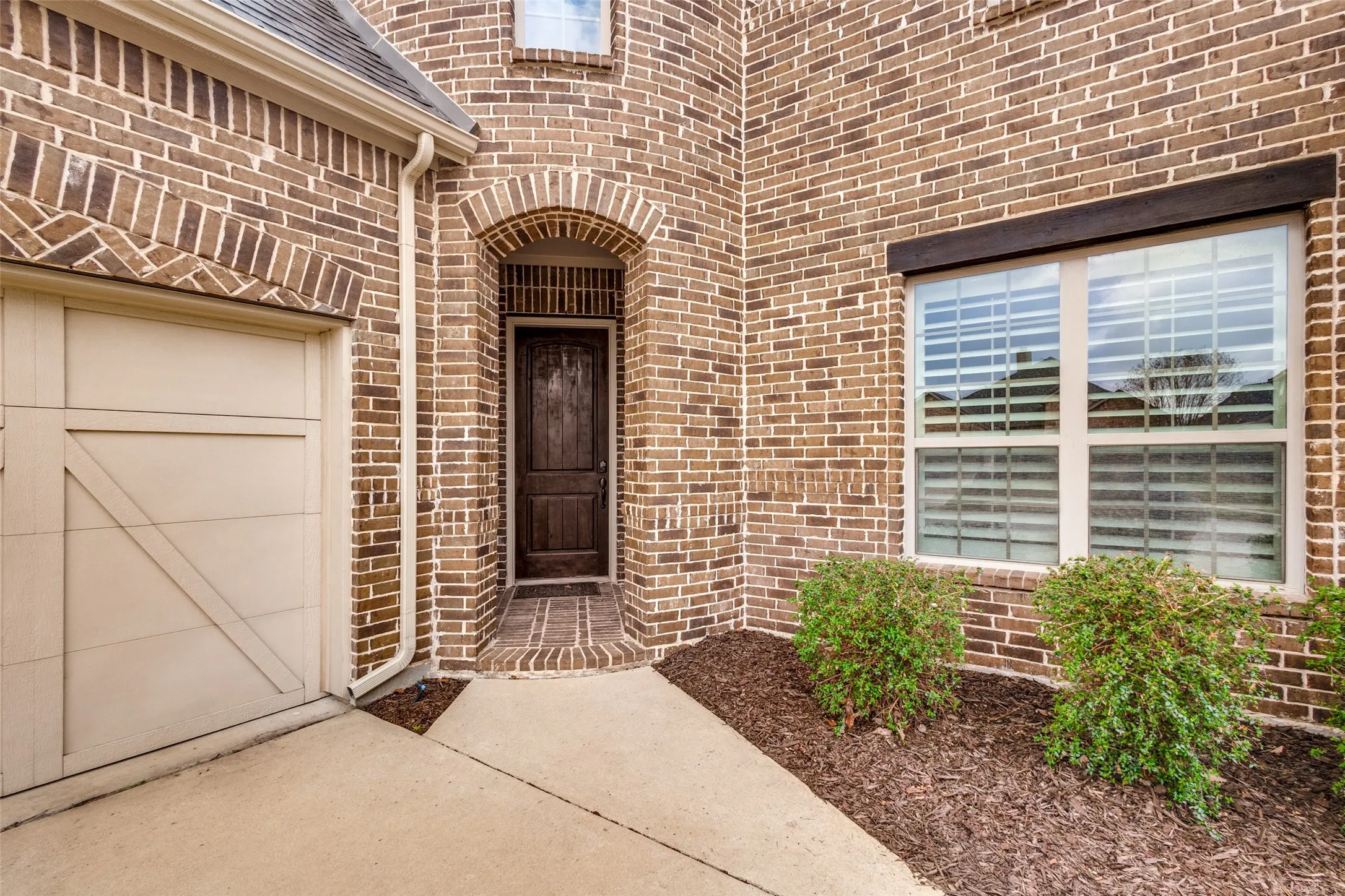 Doorway to property with brick siding