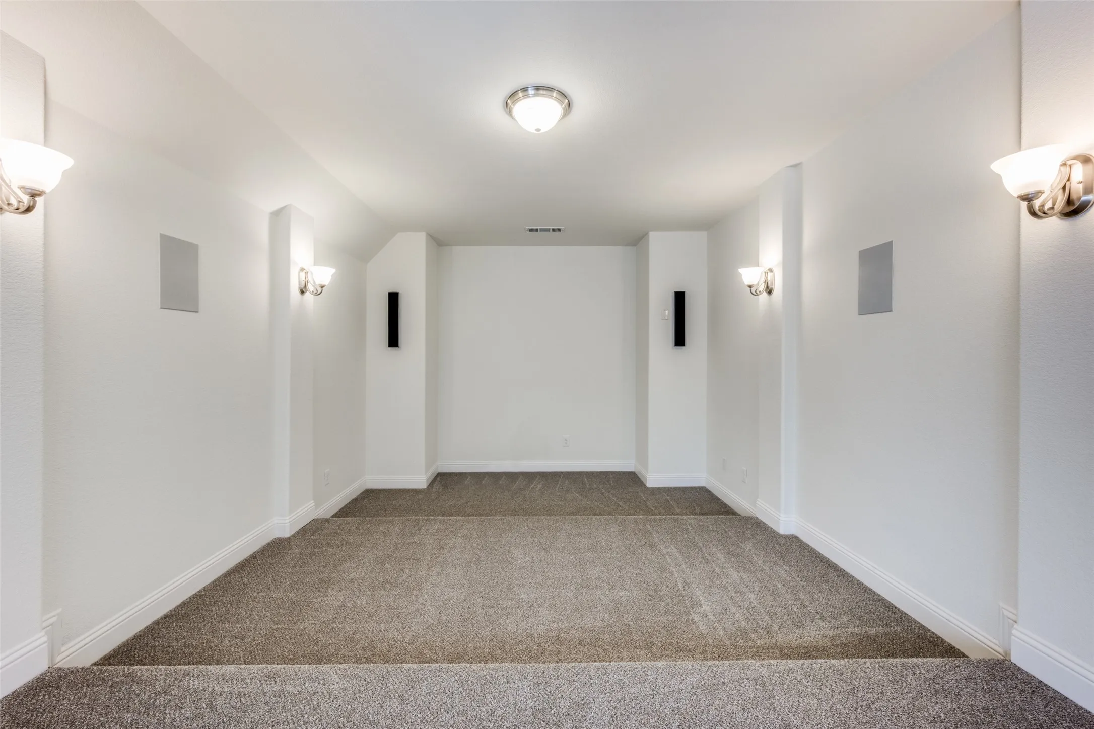 Hall featuring carpet and baseboards