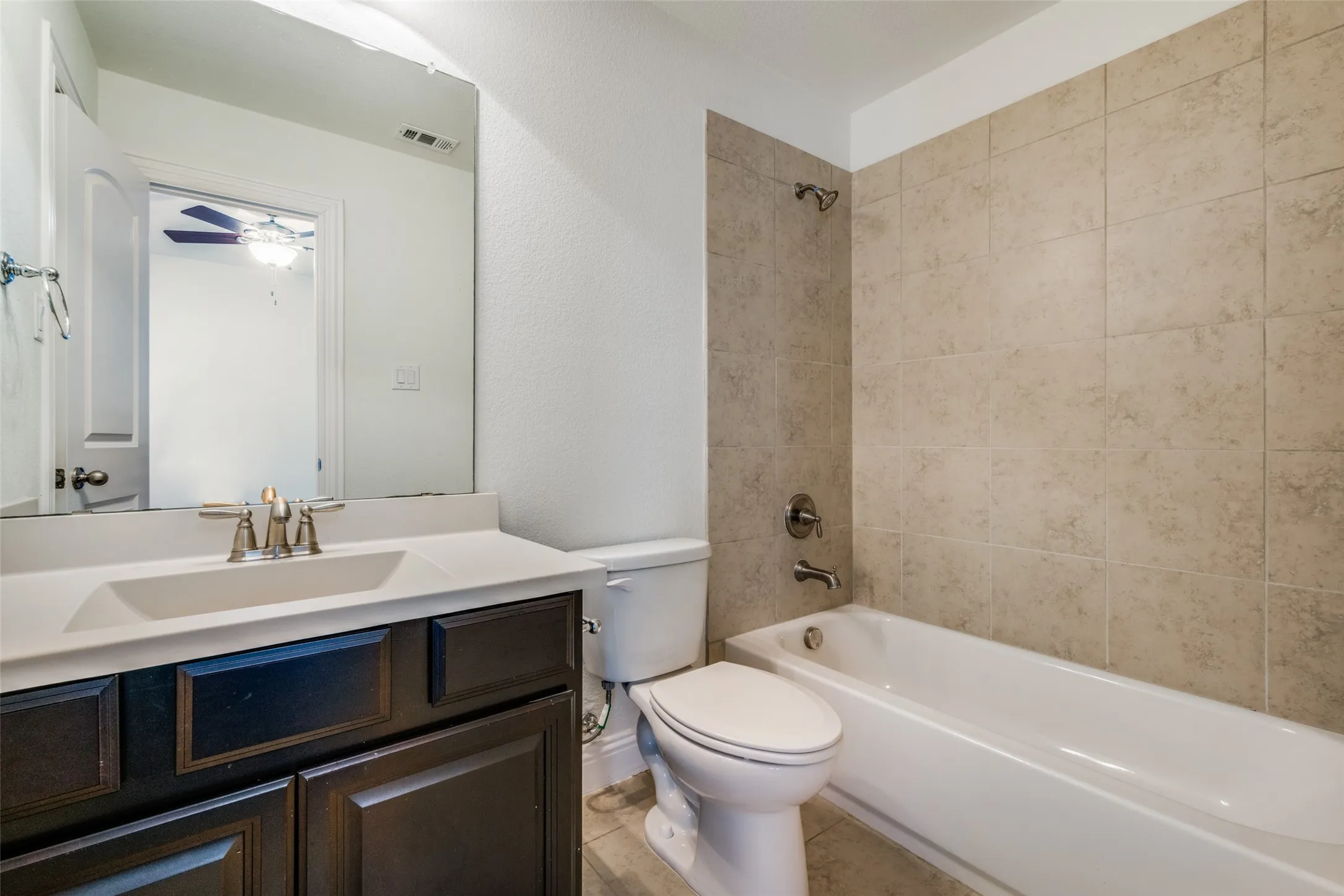 Bathroom with vanity and bathing tub / shower combination