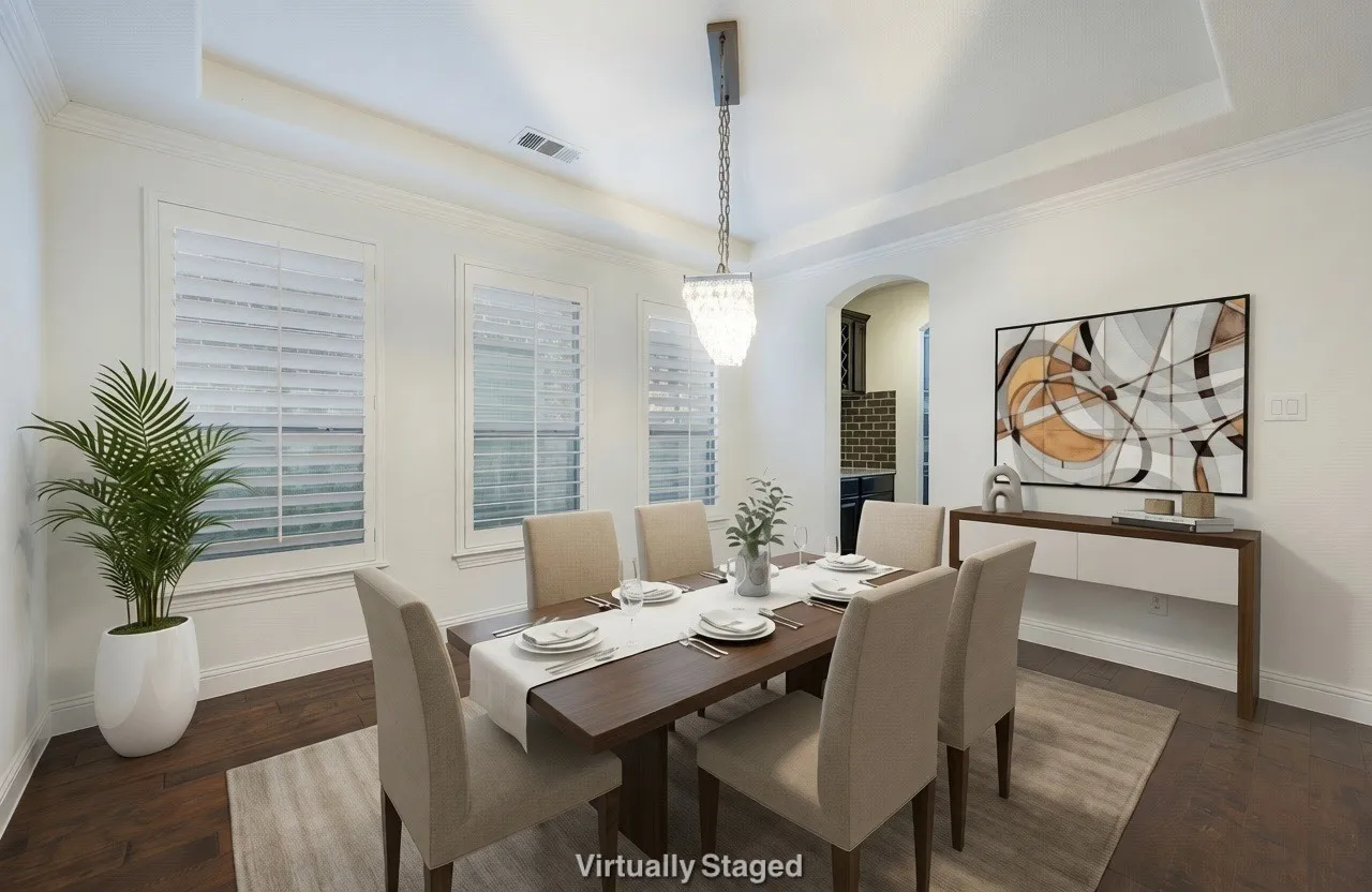 Dining room with a raised ceiling, arched walkways, crown molding, and dark wood-style flooring