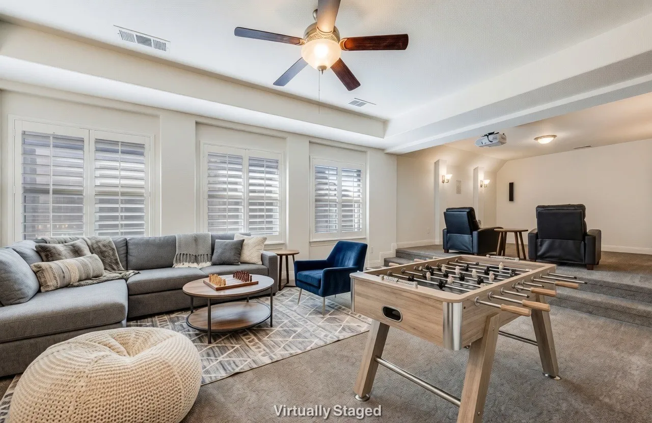 Rec room featuring a ceiling fan and a raised ceiling