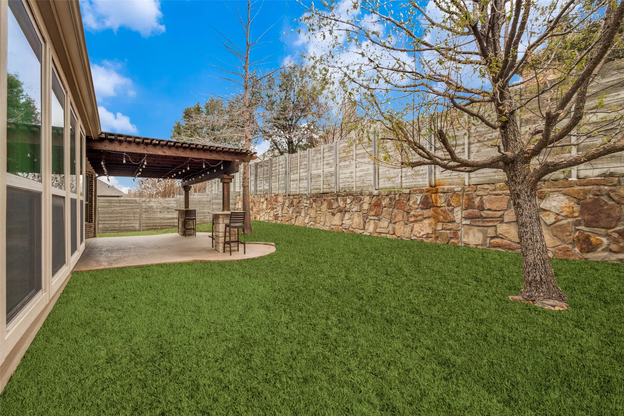 Fenced backyard featuring a patio area and a pergola