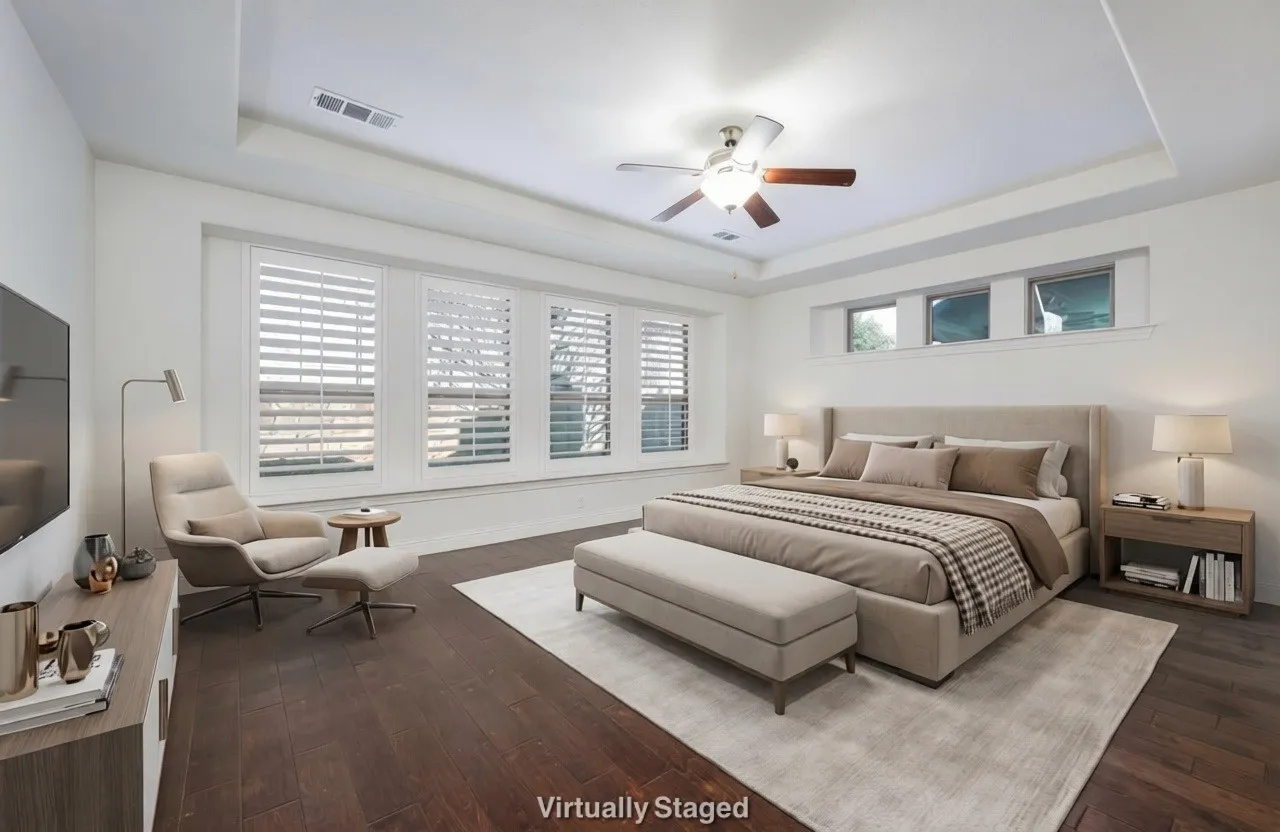 Bedroom featuring a tray ceiling, ceiling fan, and dark wood finished floors