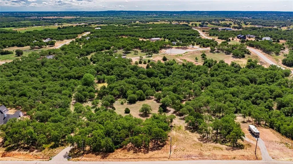 Aerial view of the 2-acre lot offering lots of trees and beautiful rolling terrain.