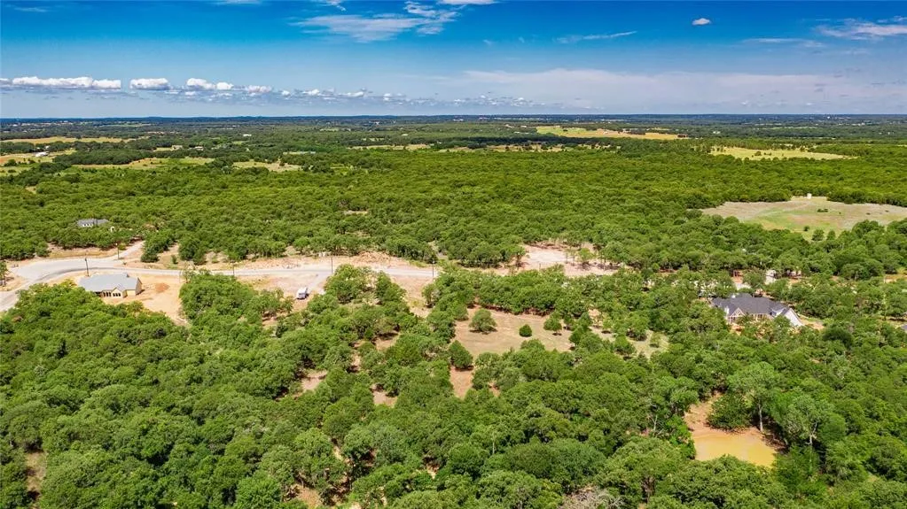 Aerial view of the 2-acre lot offering lots of trees and beautiful rolling terrain.