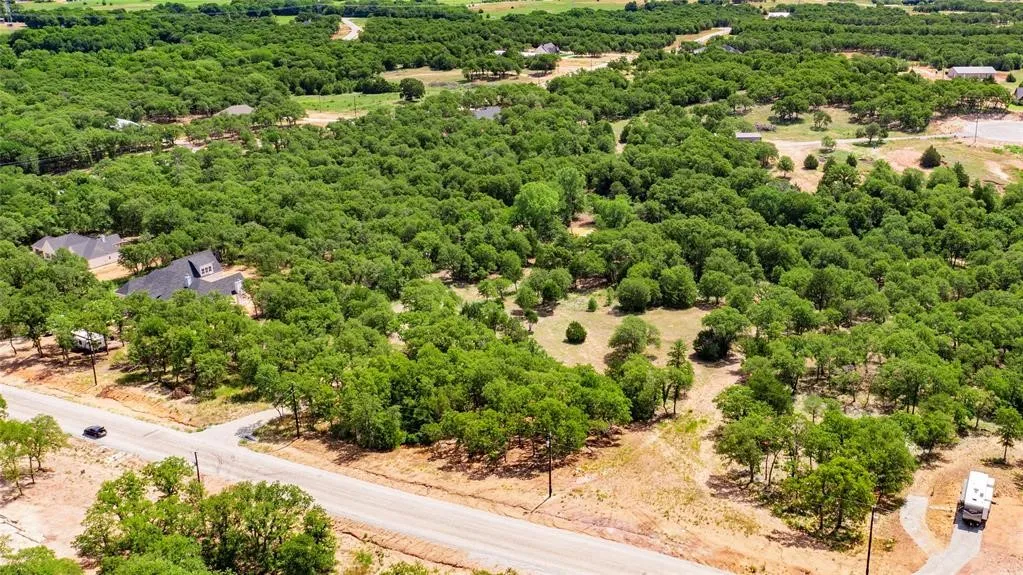 Aerial view of the 2-acre lot offering lots of trees and beautiful rolling terrain.