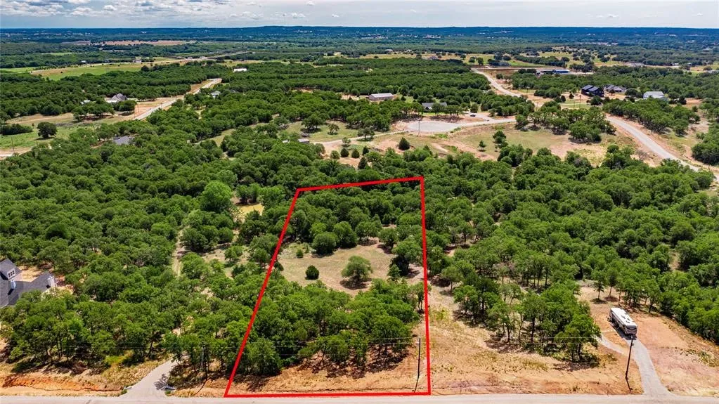 Aerial view of the 2-acre lot offering lots of trees and beautiful rolling terrain.