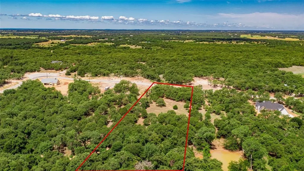 Aerial view of the 2-acre lot offering lots of trees and beautiful rolling terrain.