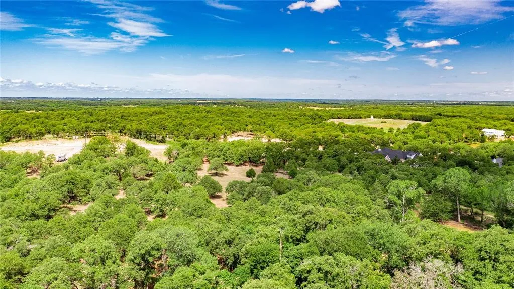 Aerial view of the 2-acre lot offering lots of trees and beautiful rolling terrain.