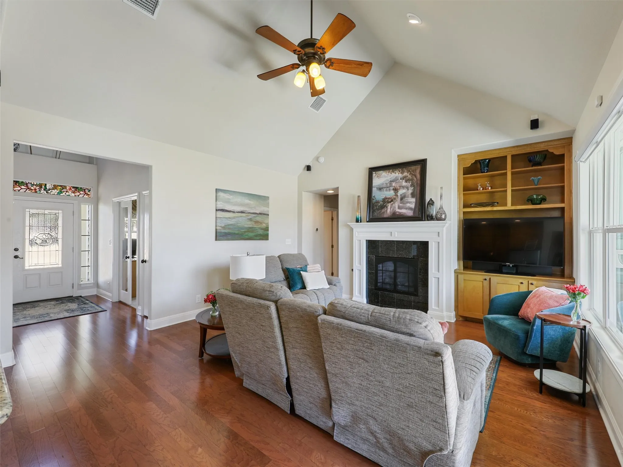 Large Open Living Area with Oak Flooring, Gas Fireplace and High Tray Ceilings