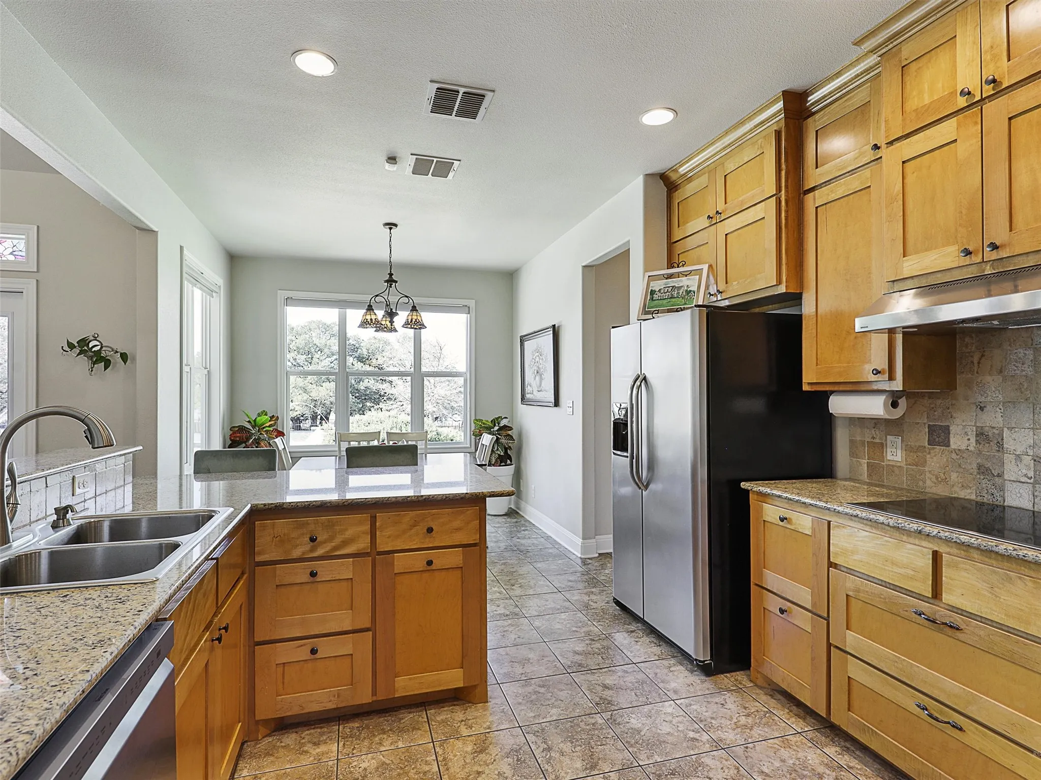 Open Kitchen with Plenty of Maple Cabinets for Storage
