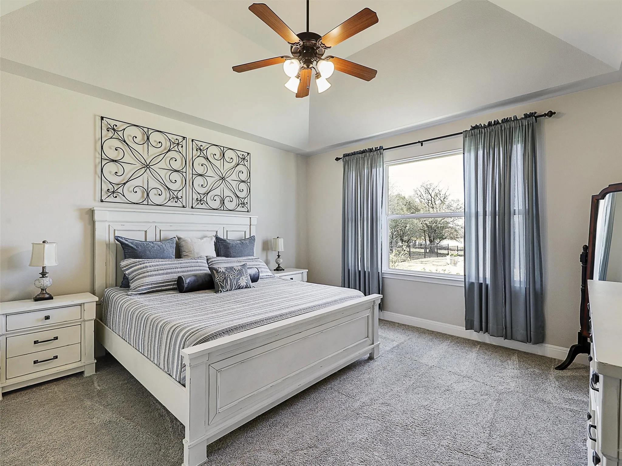 Primary Bedroom with Tray Ceiling and Picture Window for a Great View of the Backyard and Open Spaces
