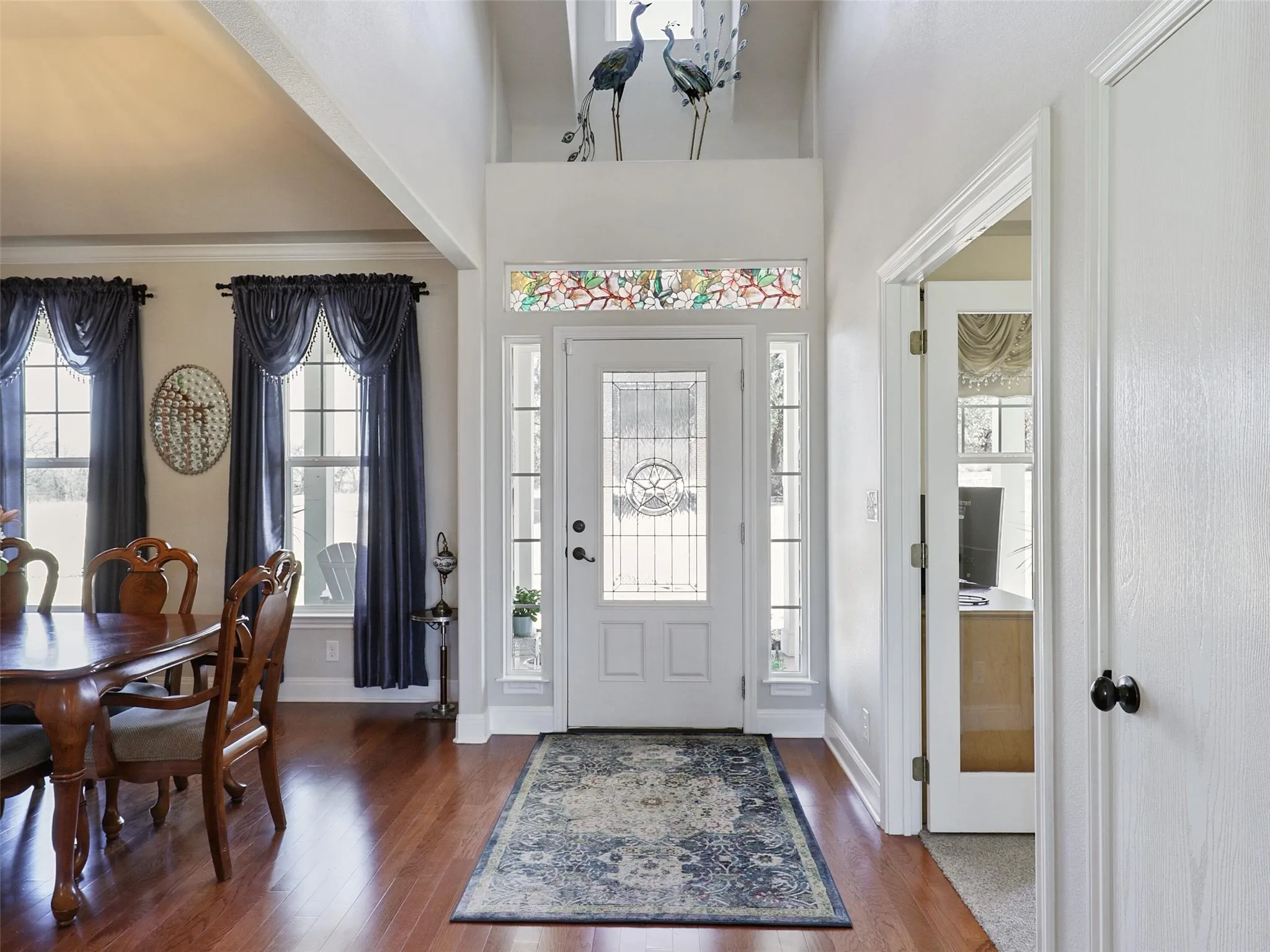Large Open Entry with High Ceilings and the Formal Dining Room on one side, and Dedicated Office on the Other