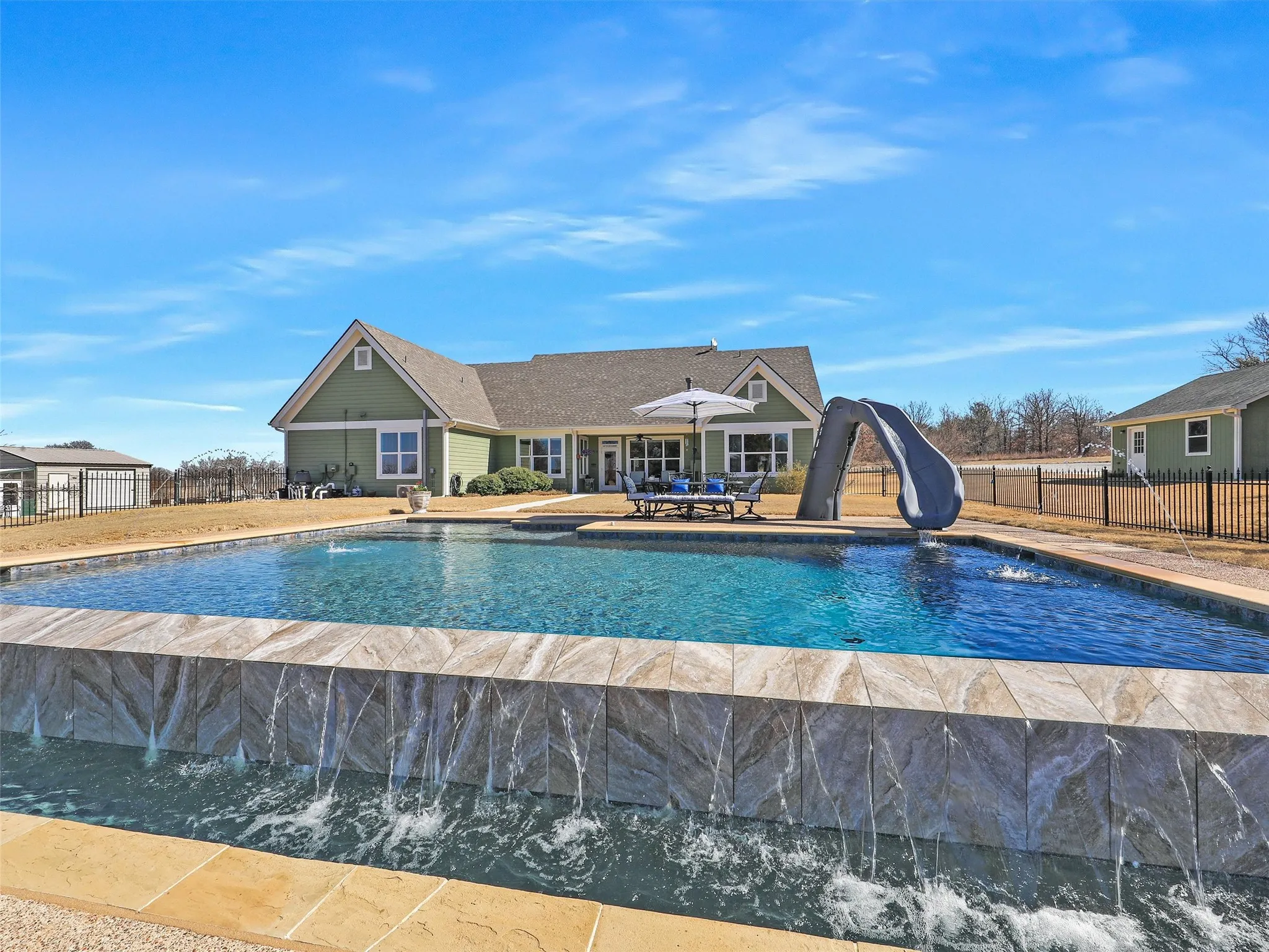 Infintiy Pool with Slide and Plenty of Decking and Patio Space for Entertaining.