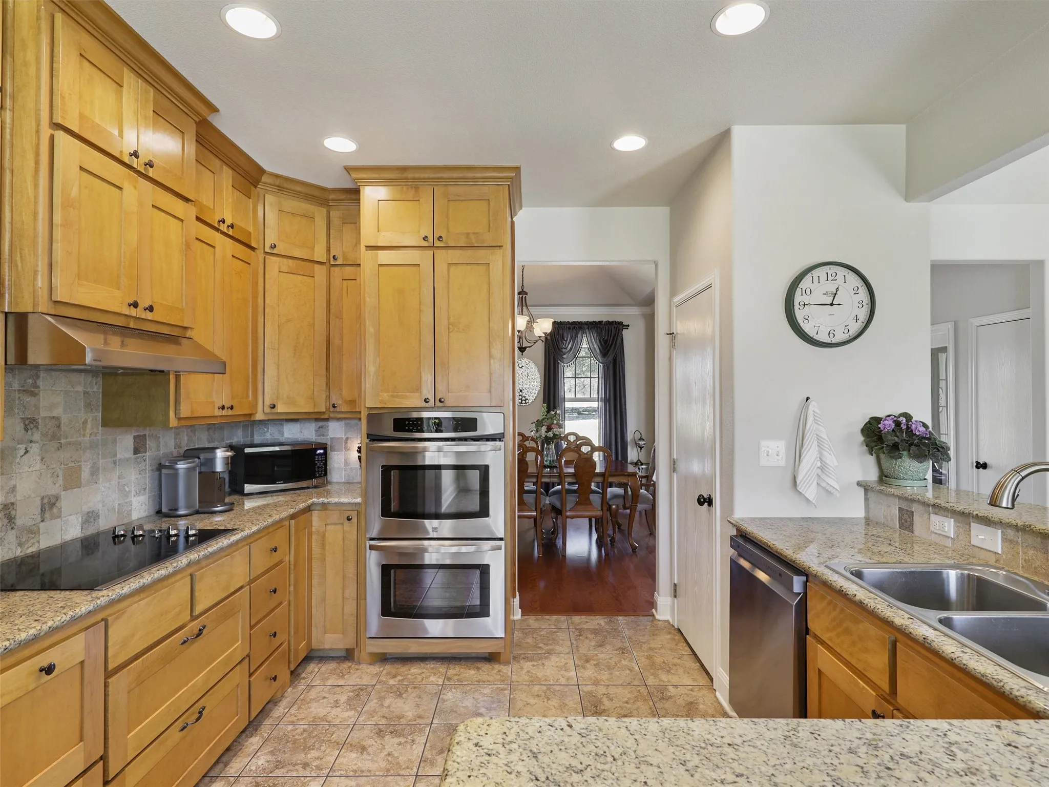 Large Open Kitchen with Moon Valley Granite Countertops, Double Oven, and Double Sinks. All Overlooking the Large Living Area